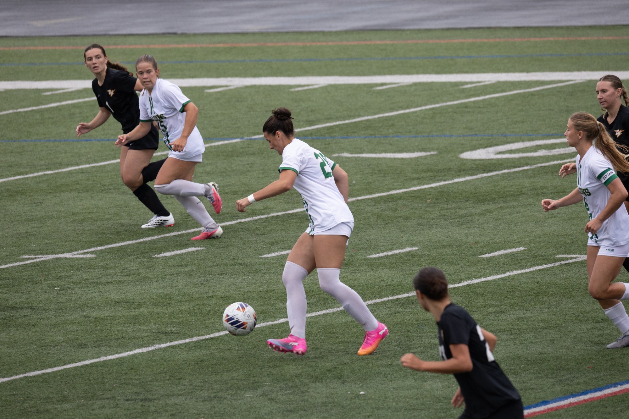 Grace DiQuattro dribbling soccer ball on field