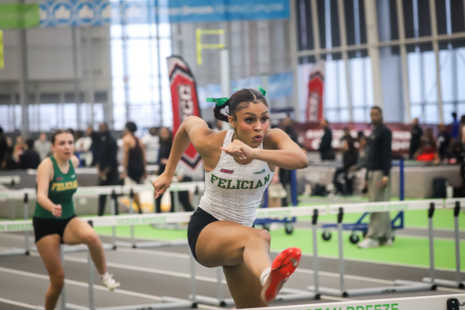 Aarysa Moore jumping over hurdles at ECC Championship