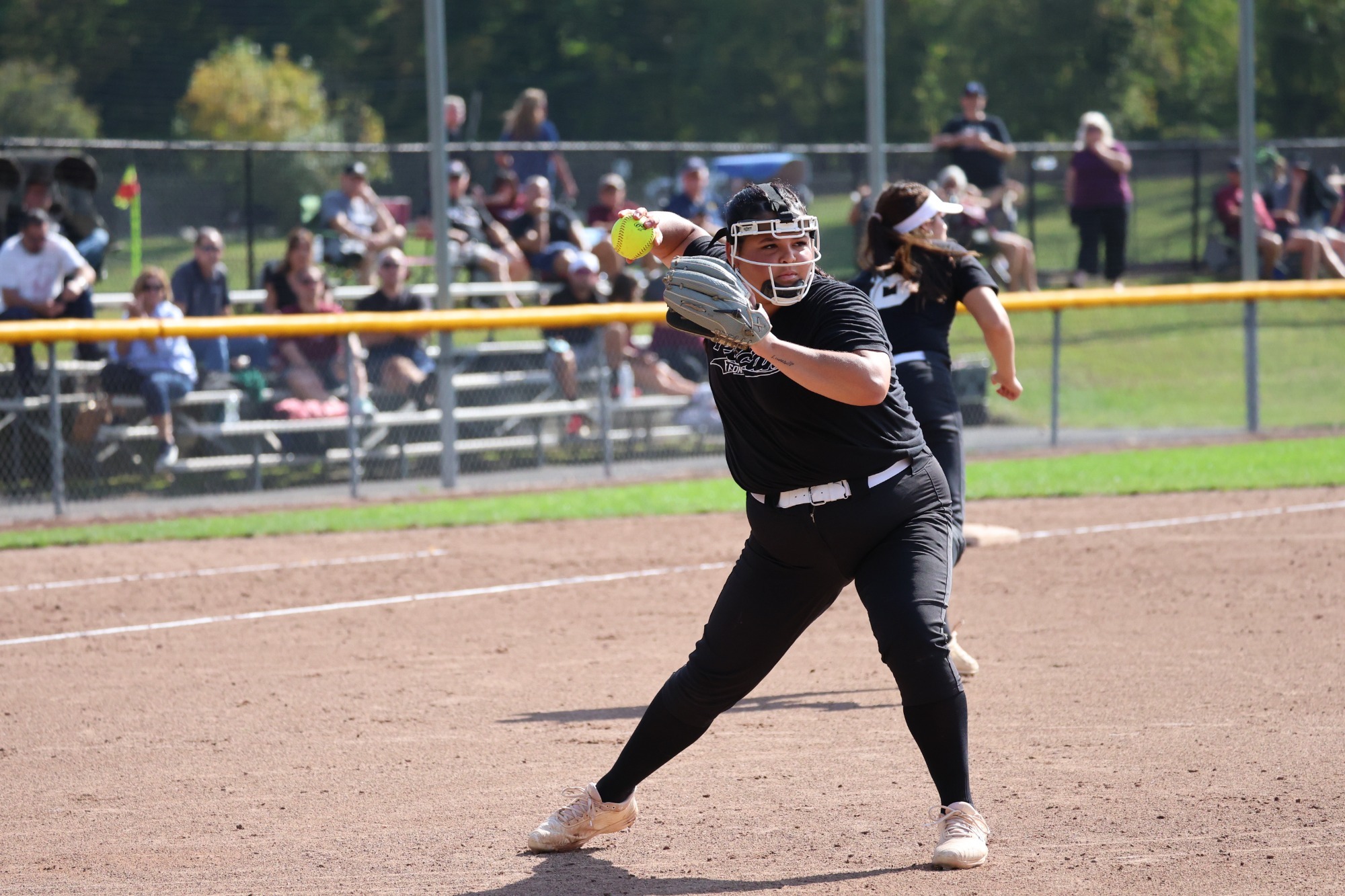 Skye Limardo throwing to first base.