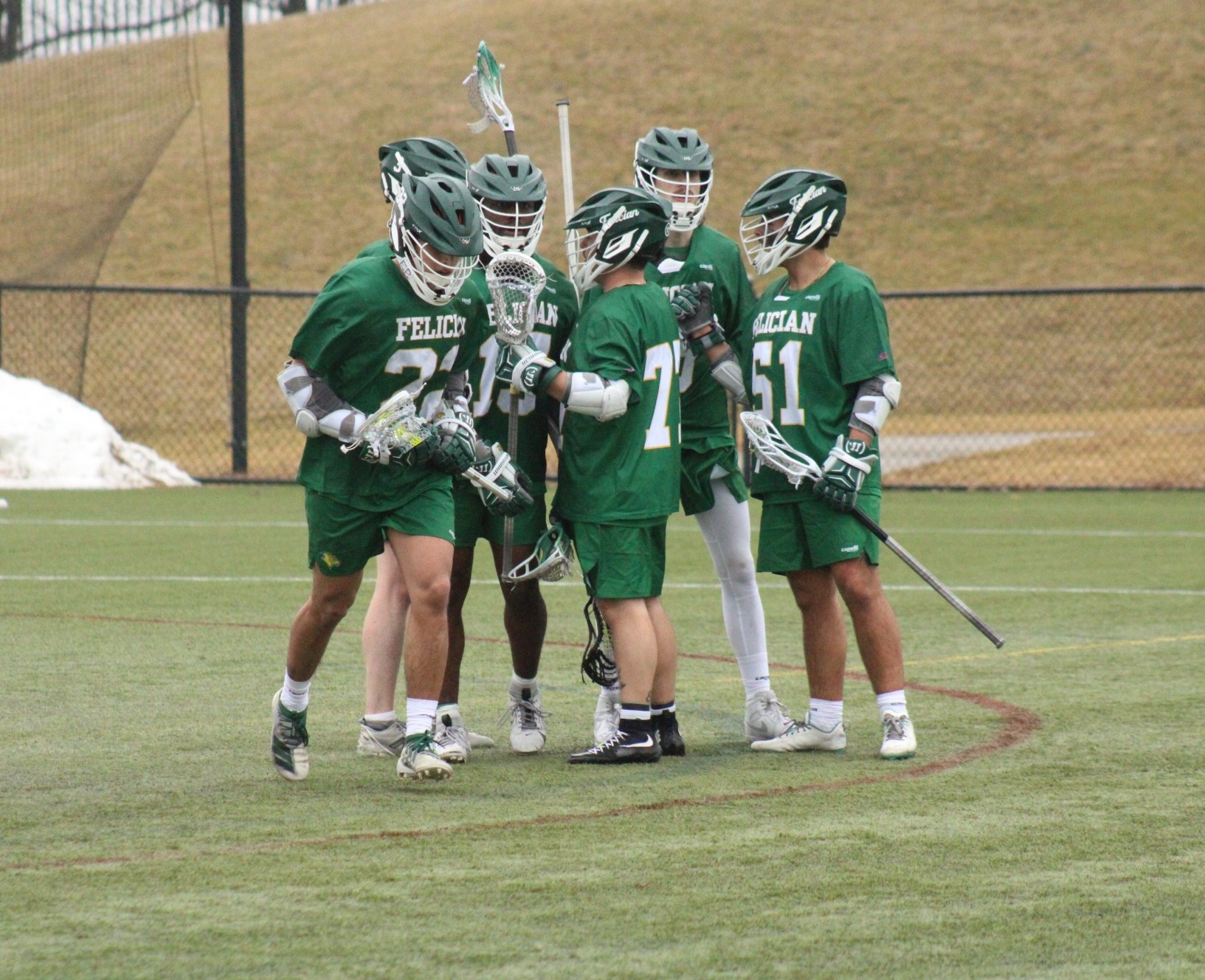 Felician Lacrosse's Offense Huddles Together to Celebrate a Goal