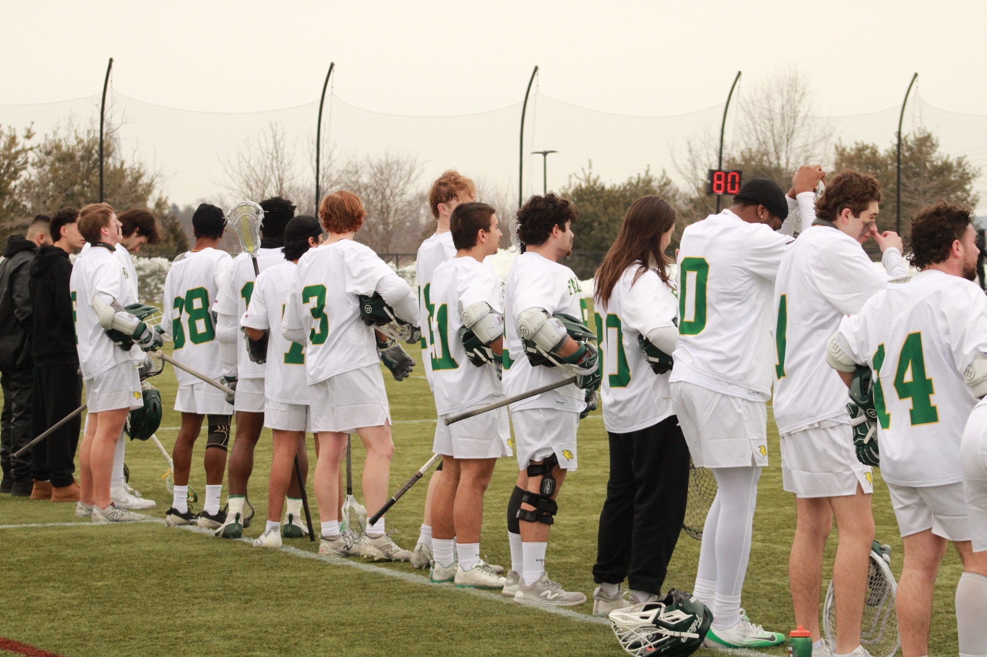 Men's Lacrosse team together during national anthem