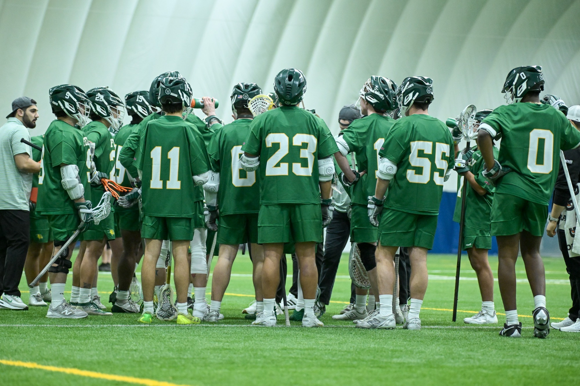 Men's Lacrosse team getting water during timeout