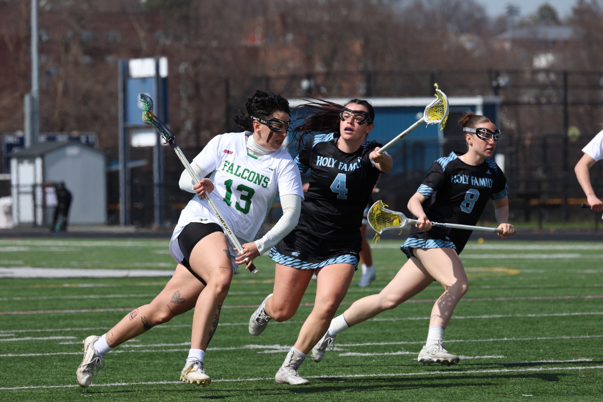 Natalia Ogando running past a Holy Family Defenseman