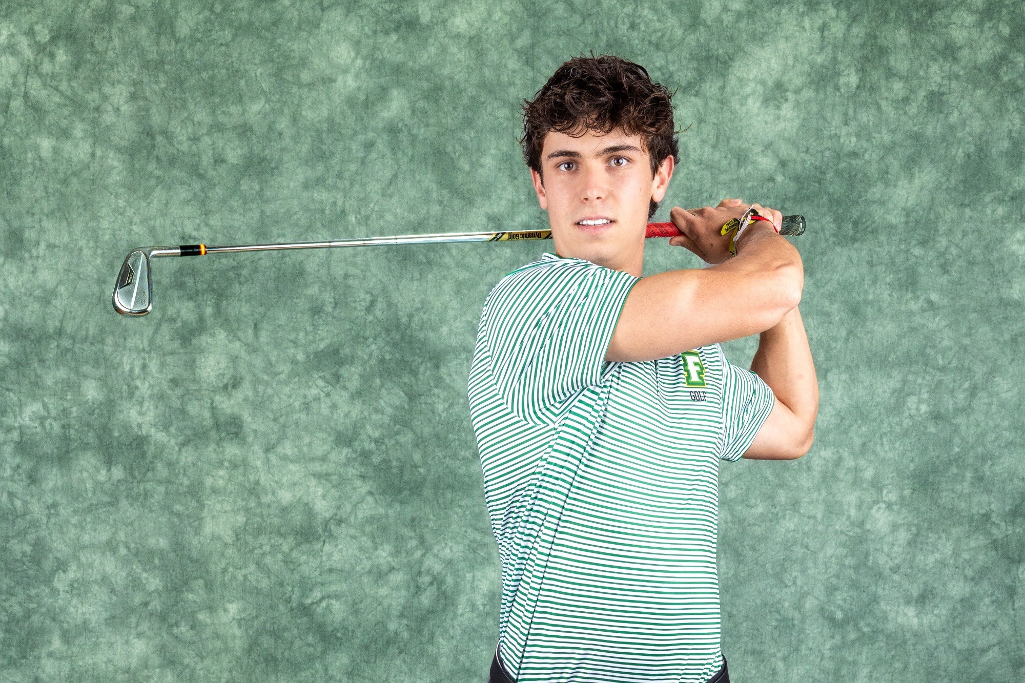 Carlos Ferreira posing on media day, swinging golf club