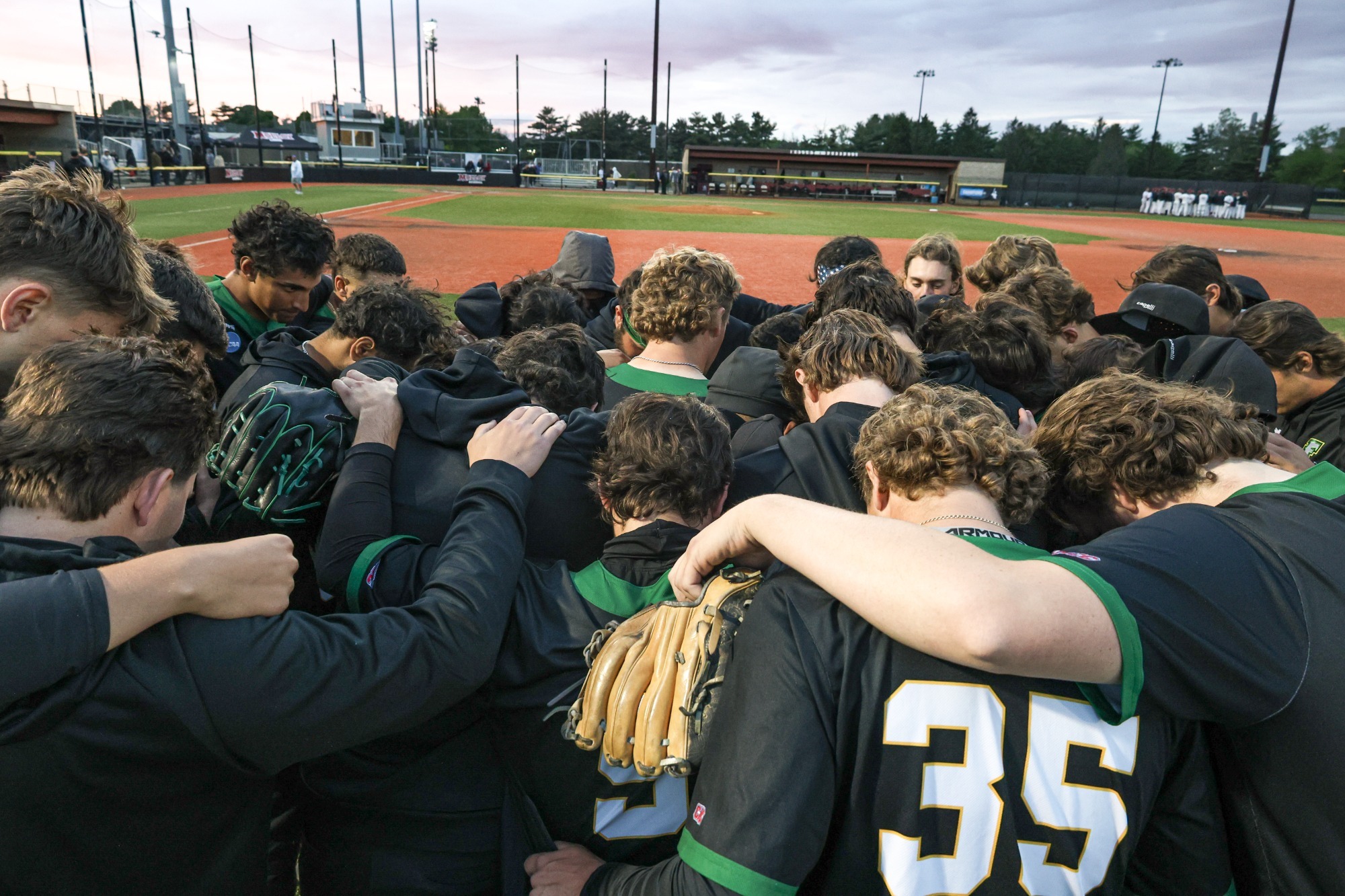 Baseball during a team prayer.
