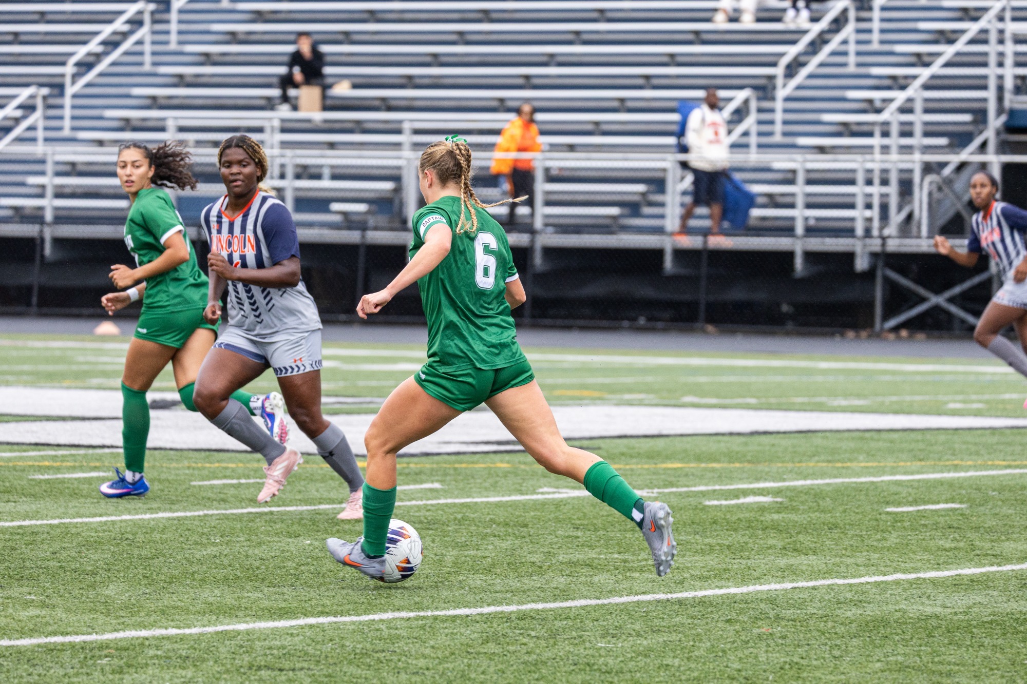 April Fischer passing ball against Lincoln