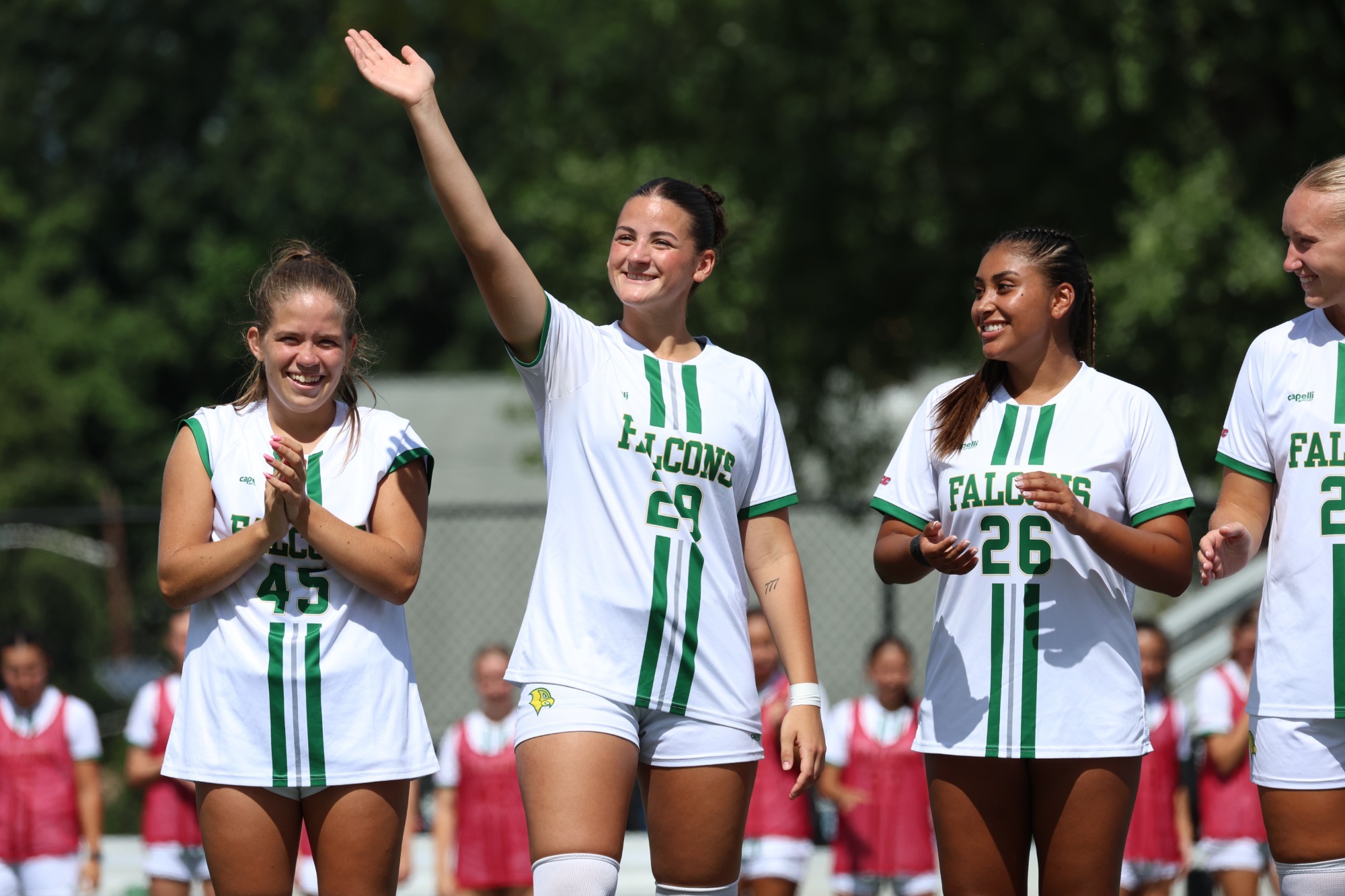 Grace DiQuattro waving to fans during pre-game lineup announcement