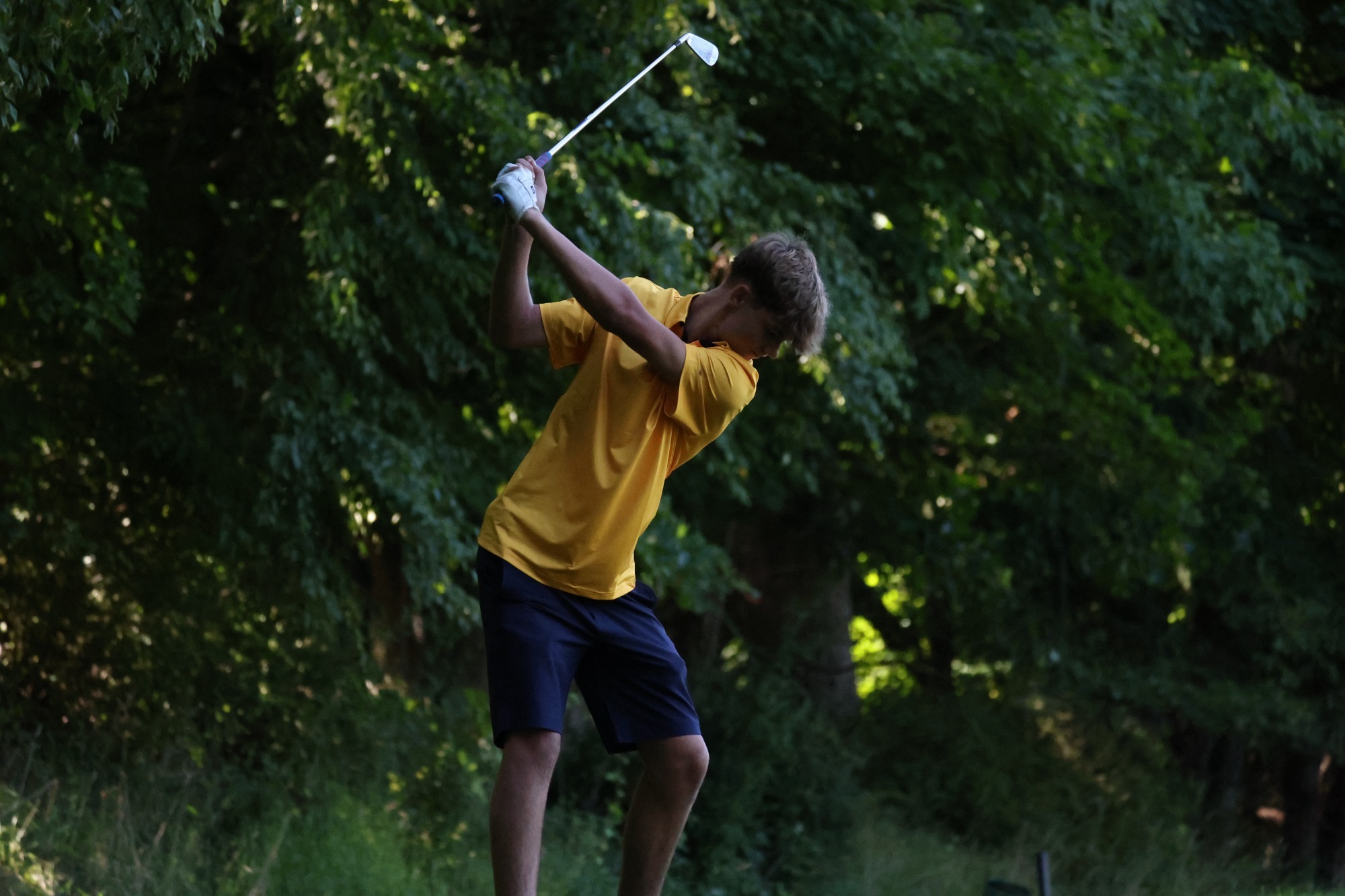 Men's Golfer swinging off the tee