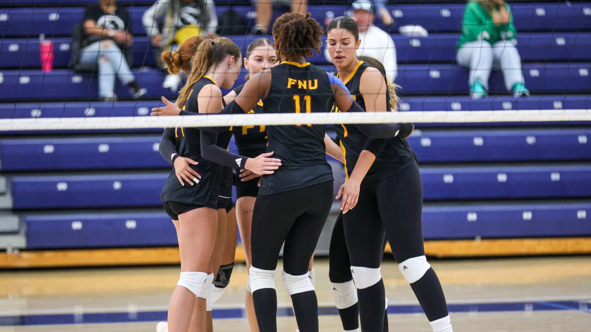 FNU volleyball in a huddle after a point at Keiser Tournament 2025