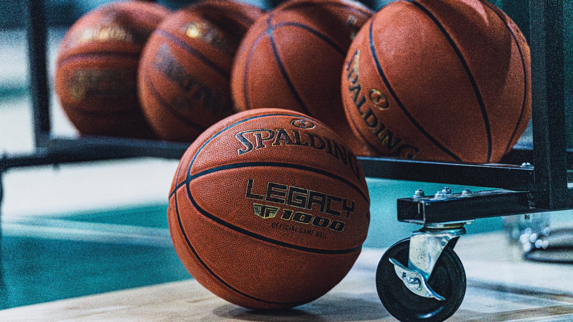 Spalding basketballs racked up and one on the floor before Florida National plays Webber International 2025-26