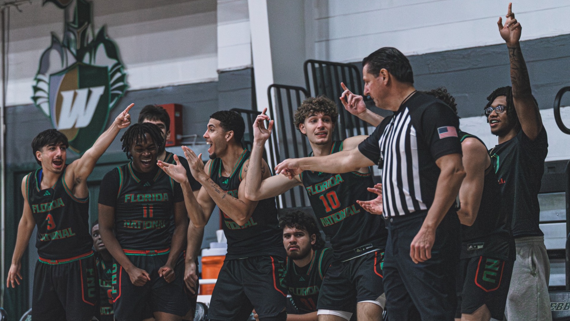 FNU men's basketball's bench celebrating against Warner University 2025-26