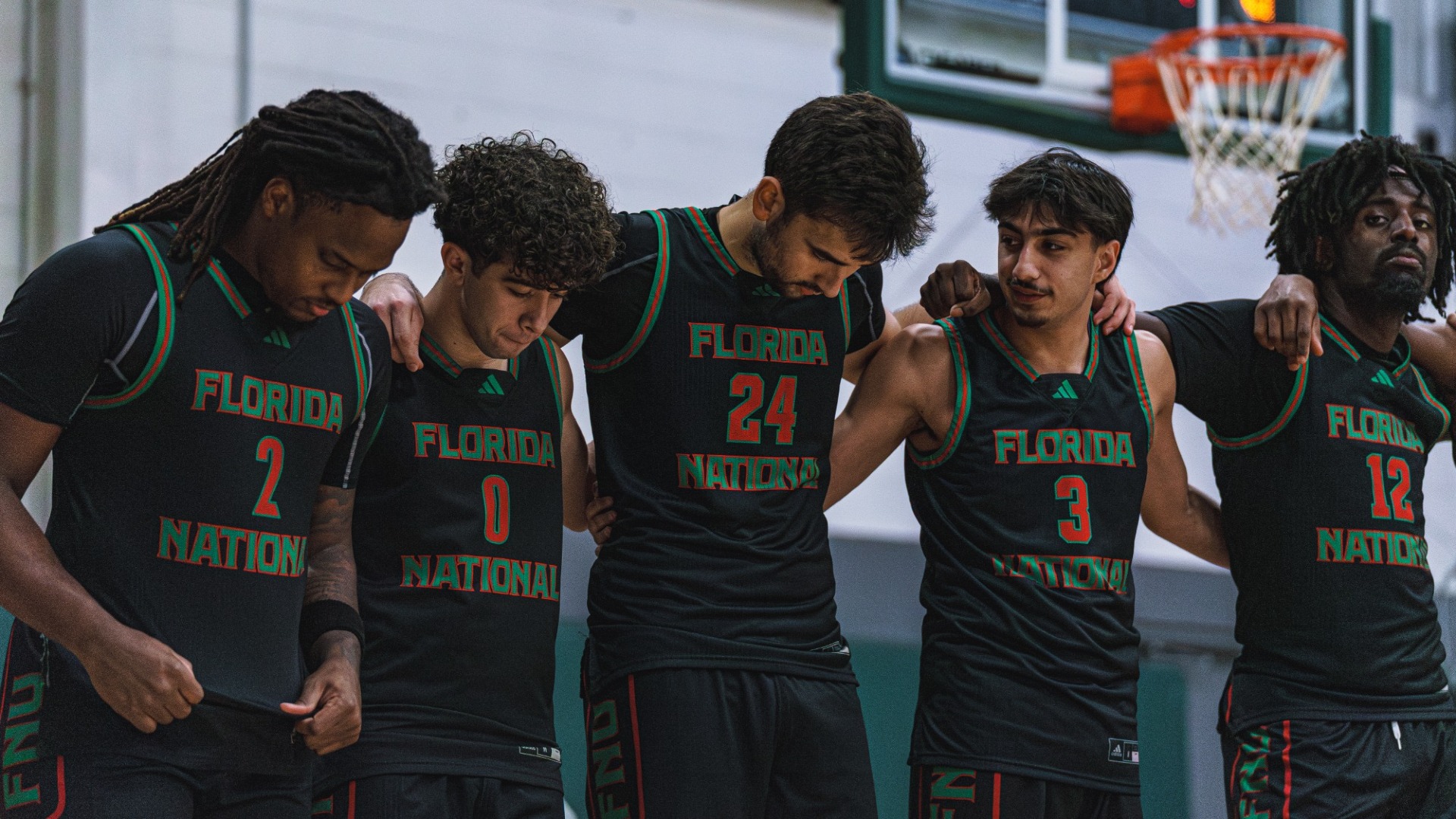 FNU men's basketball in a line, locked arms before facing Warner University 2025-26