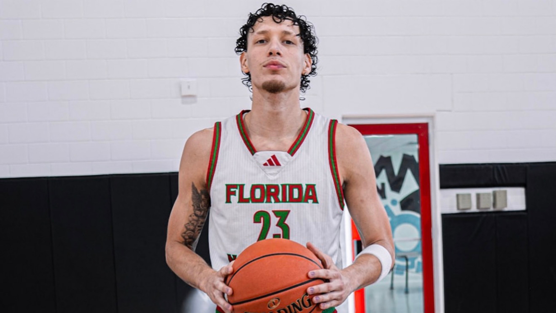 Anthony Salazar during men's basketball's media day, holding a basketball.