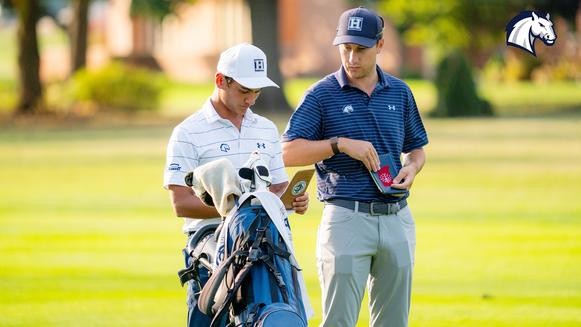 Hillsdale College golfer Oliver Marshall (left) and coach Luke Kelly check yardage on a hole during the Doc Spragg Invitational on Oct. 13, 2025.