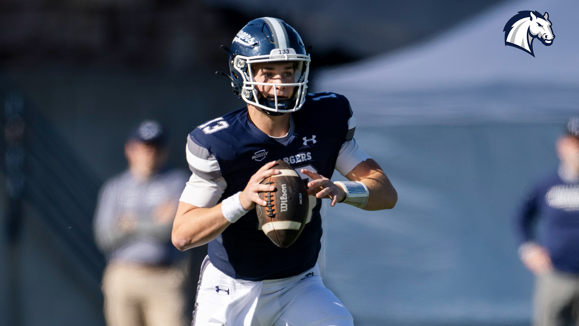 Quarterback Colin McKernan rolls out of the pocket and looks for a receiver against Lake Erie on Oct. 25, 2025.