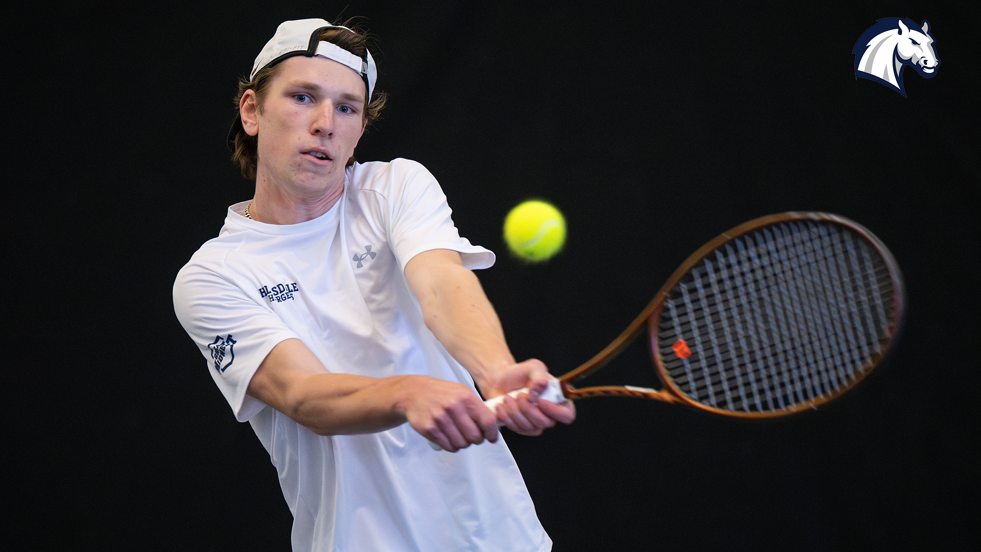 Hillsdale's Eddie Bergelin hits a return shot during a match against Northwood on April 12, 2025.