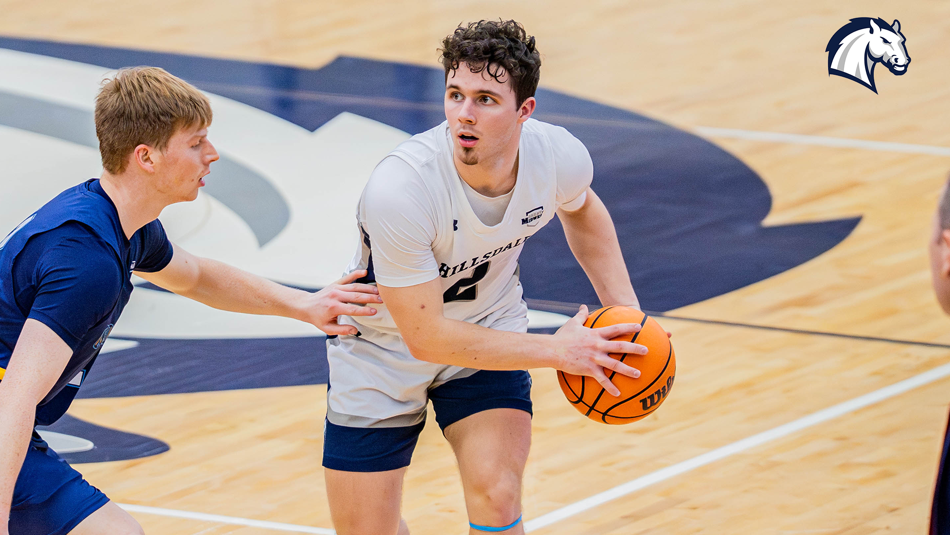 Hillsdale's Ashton Janowski protects the ball from a Cedarville defender during a game on Jan. 15, 2026.