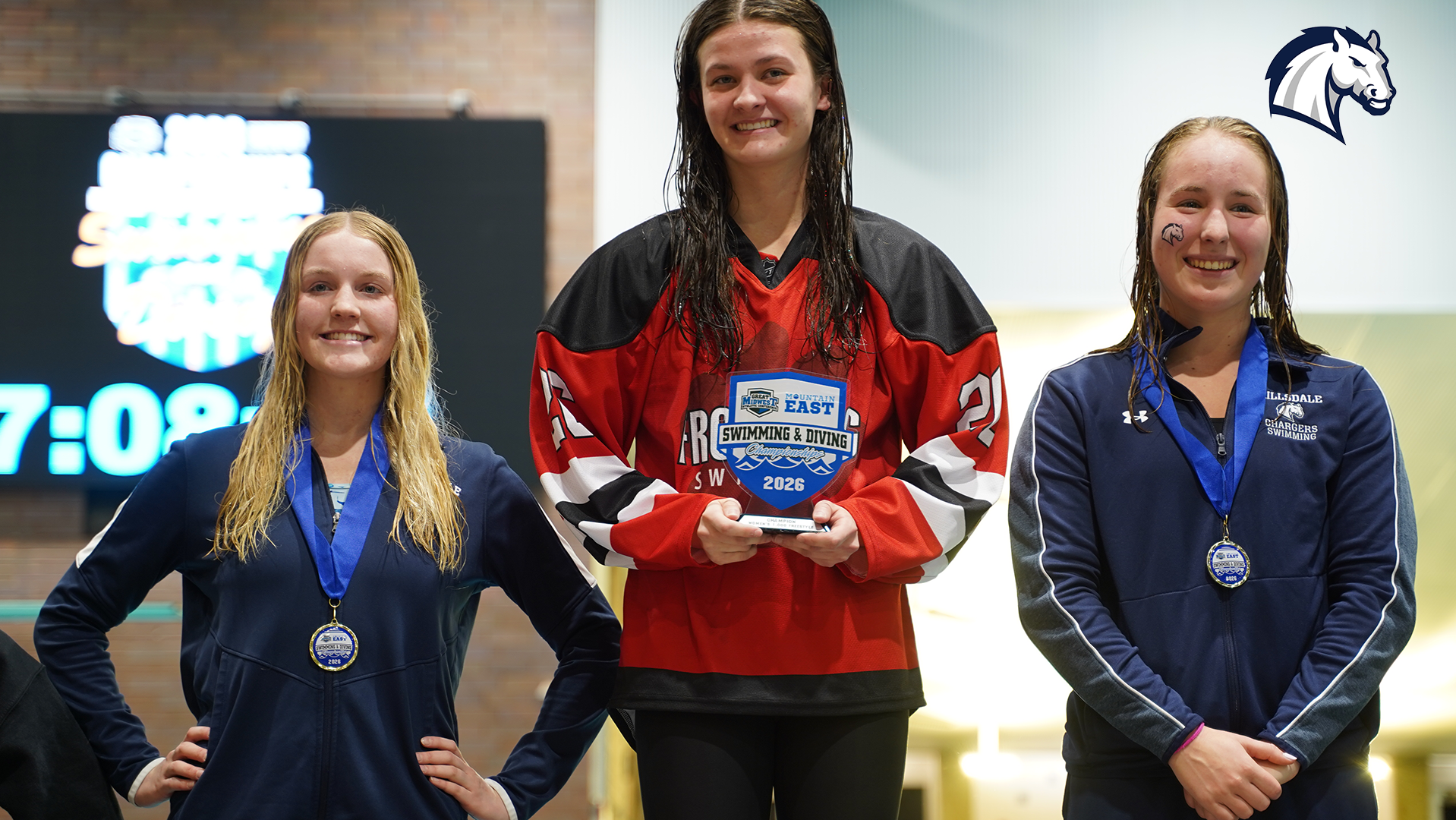 Hillsdale's Matilyn Wilhelmsen (left) and Avery May (right) pose with their medals on the awards stand at the 2026 G-MAC/MEC Championships in Canton, Ohio.