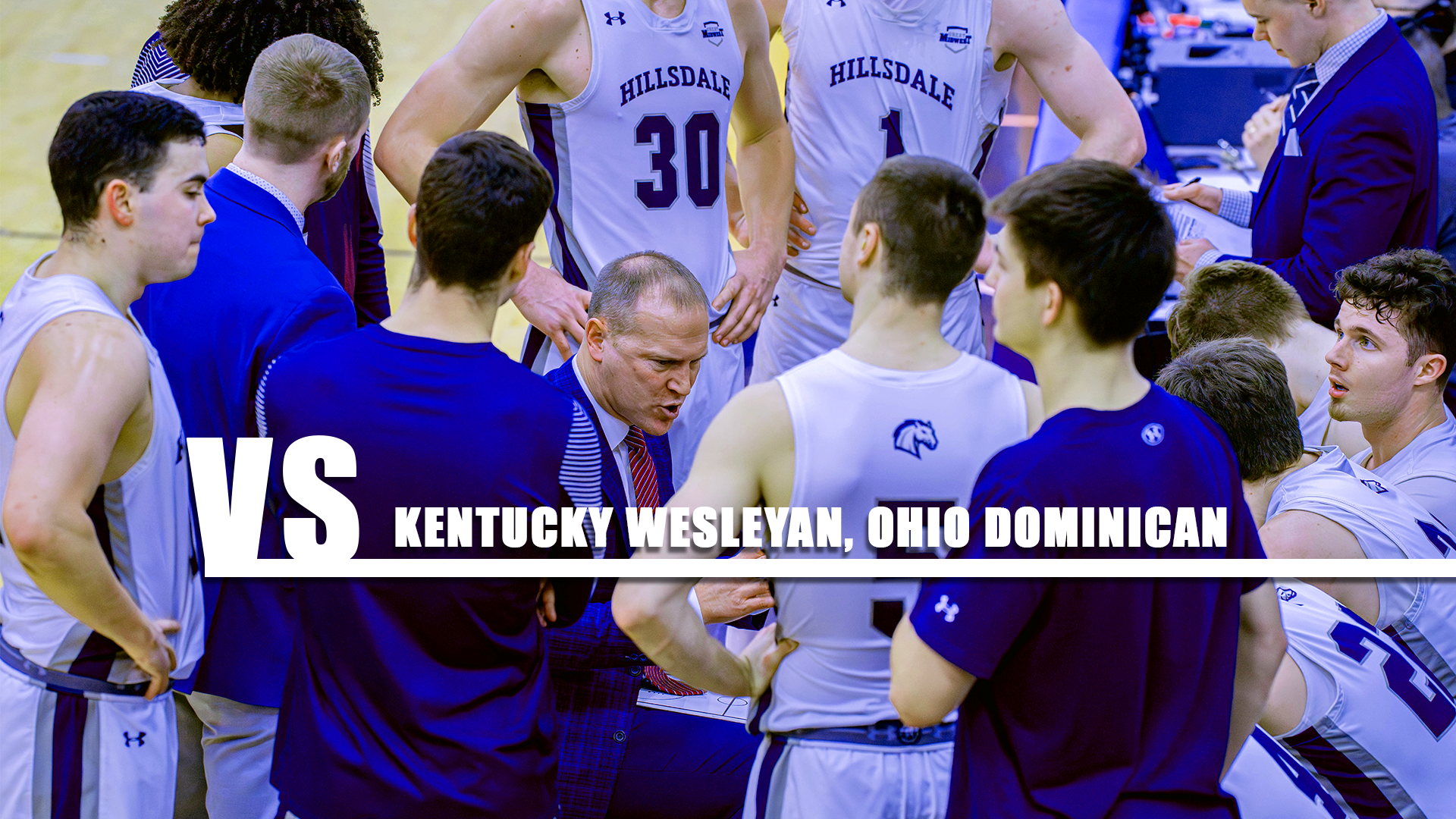 Hillsdale coach Keven Bradley adresses his team in a huddle during a timeout on Feb. 5, 2026.