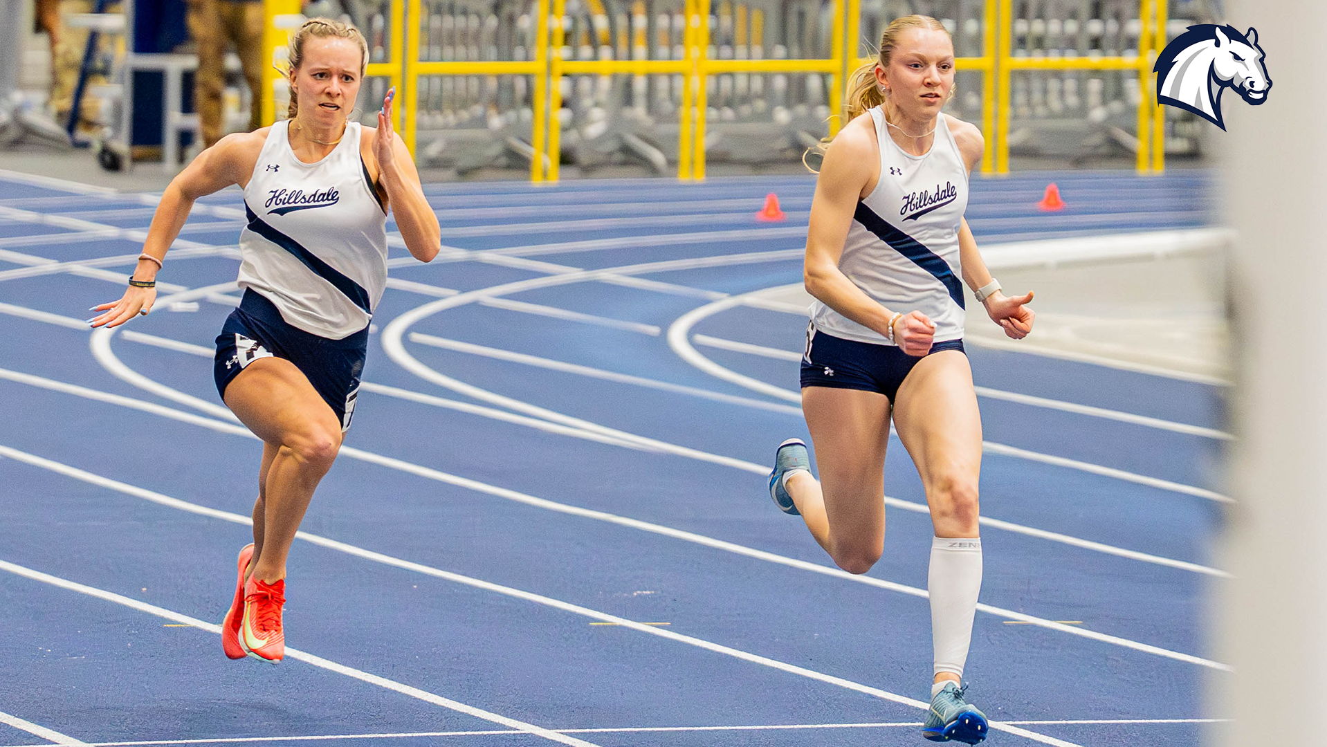 Lucy Minning (left) and Anna Roessner compete in the 200m dash at the Silverston Invitational on Feb. 20, 2026.