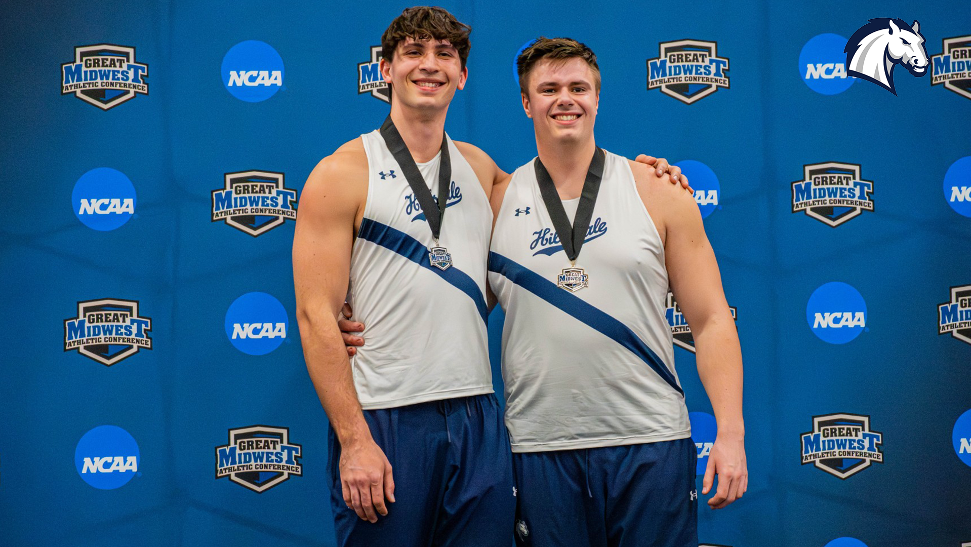 Hillsdale's Dominic Scharer (left) and Ben Haas pose after going 1-2 in the weight throw at the 2026 G-MAC Indoor Championships.