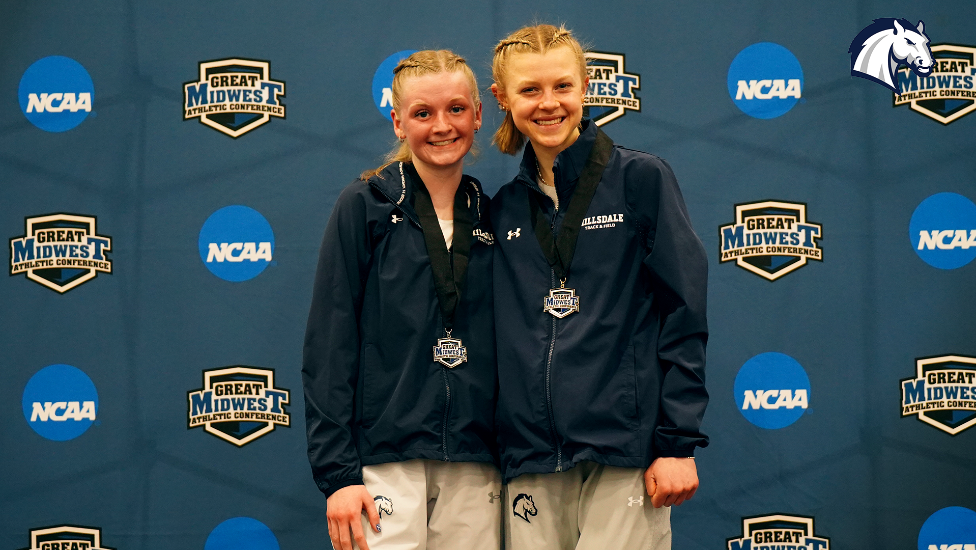 Hillsdale's Eleanor Clark (left) and Allison Kuzma pose after finishing first and second in the 5,000m run at the 2026 G-MAC Indoor Championships