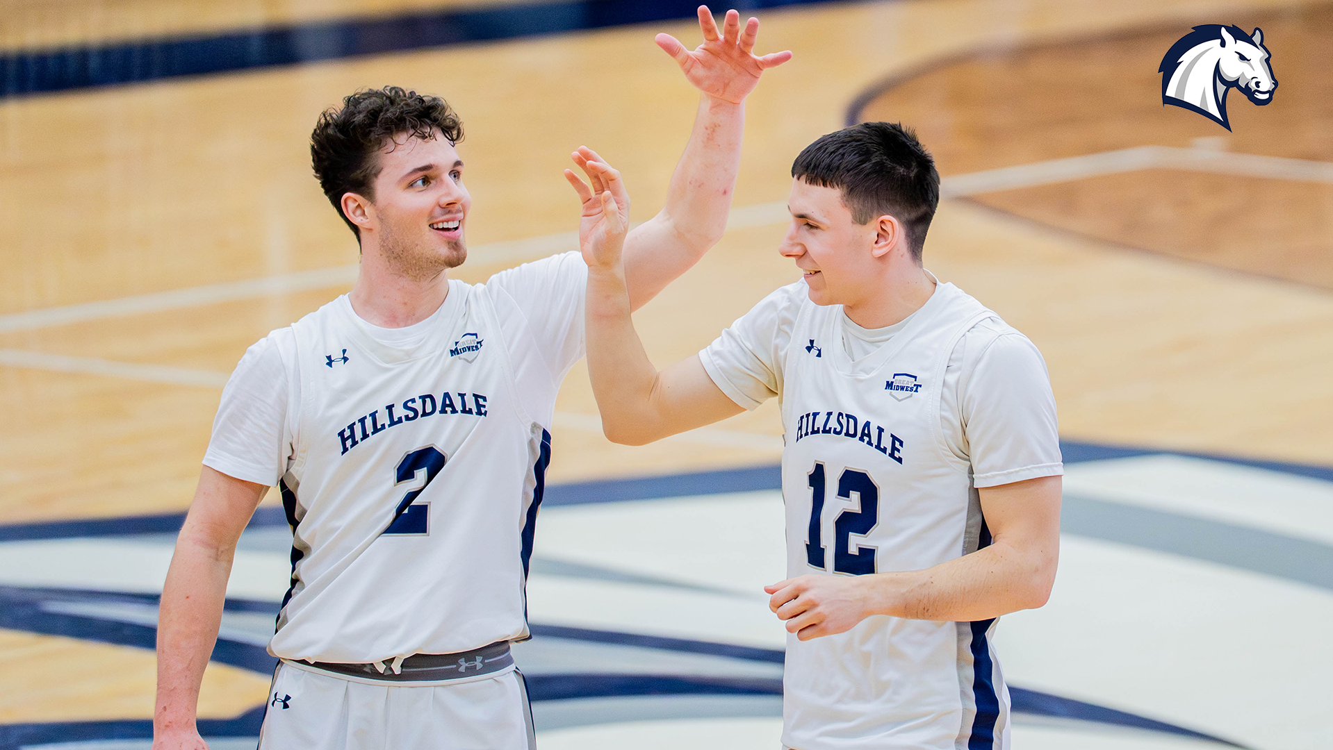 Hillsdale's Ashton Janowski (left) and Jacob Meyer high-five during a Feb. 28, 2026 contest against Northwood.
