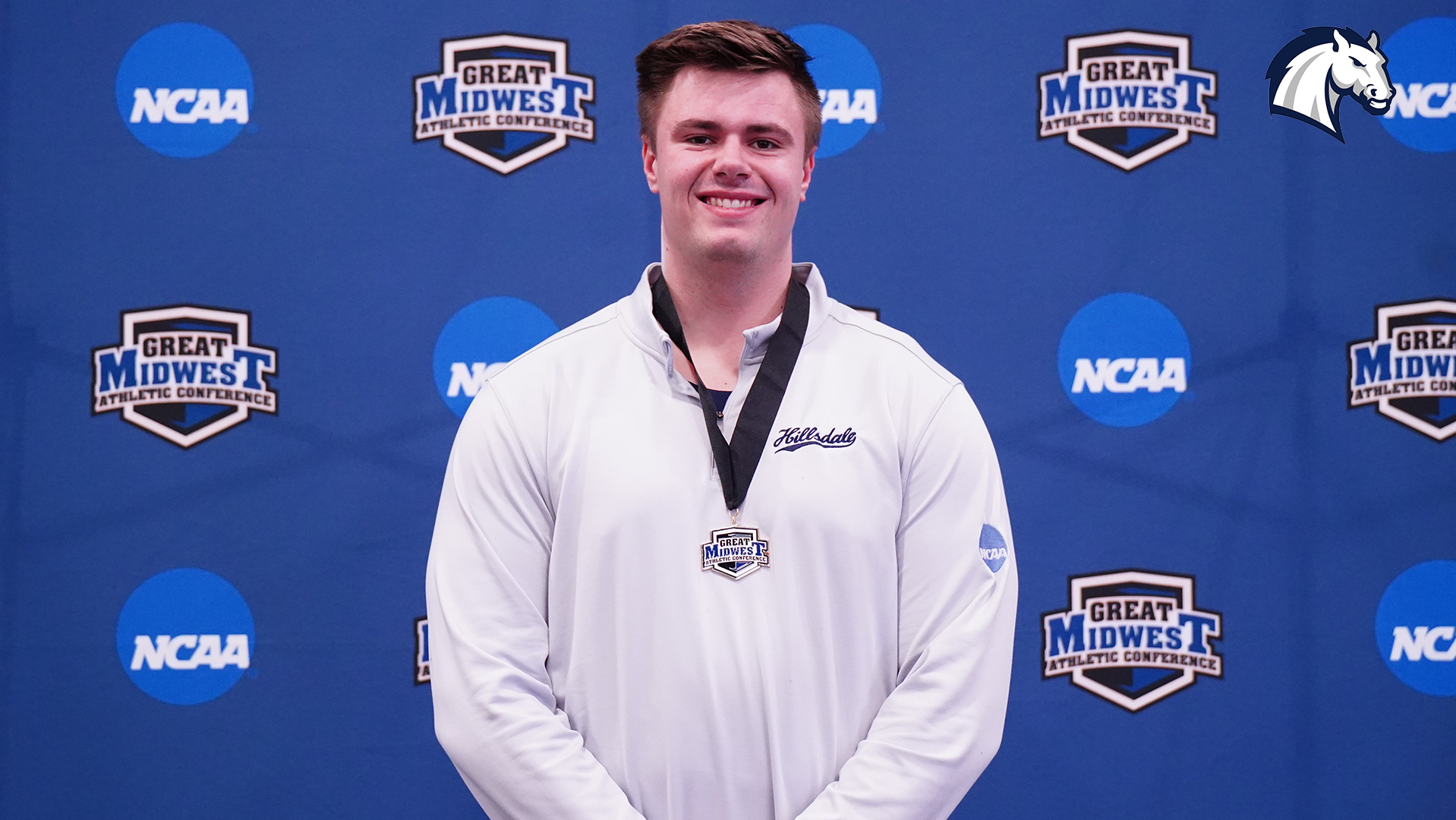 Hillsdale's Ben Haas poses with his medal after winning the shot put at the 2026 G-MAC Indoor Championships.