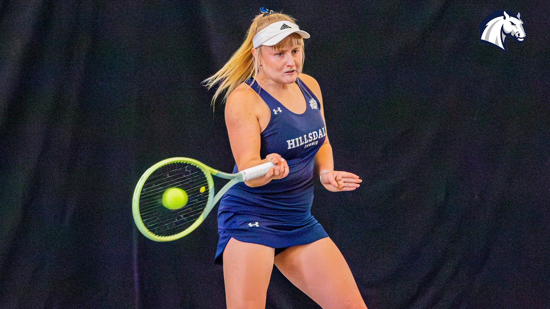 Hillsdale's Ane Dannhauser hits a forehand return during a match against Spring Arbor on Jan. 30, 2026.