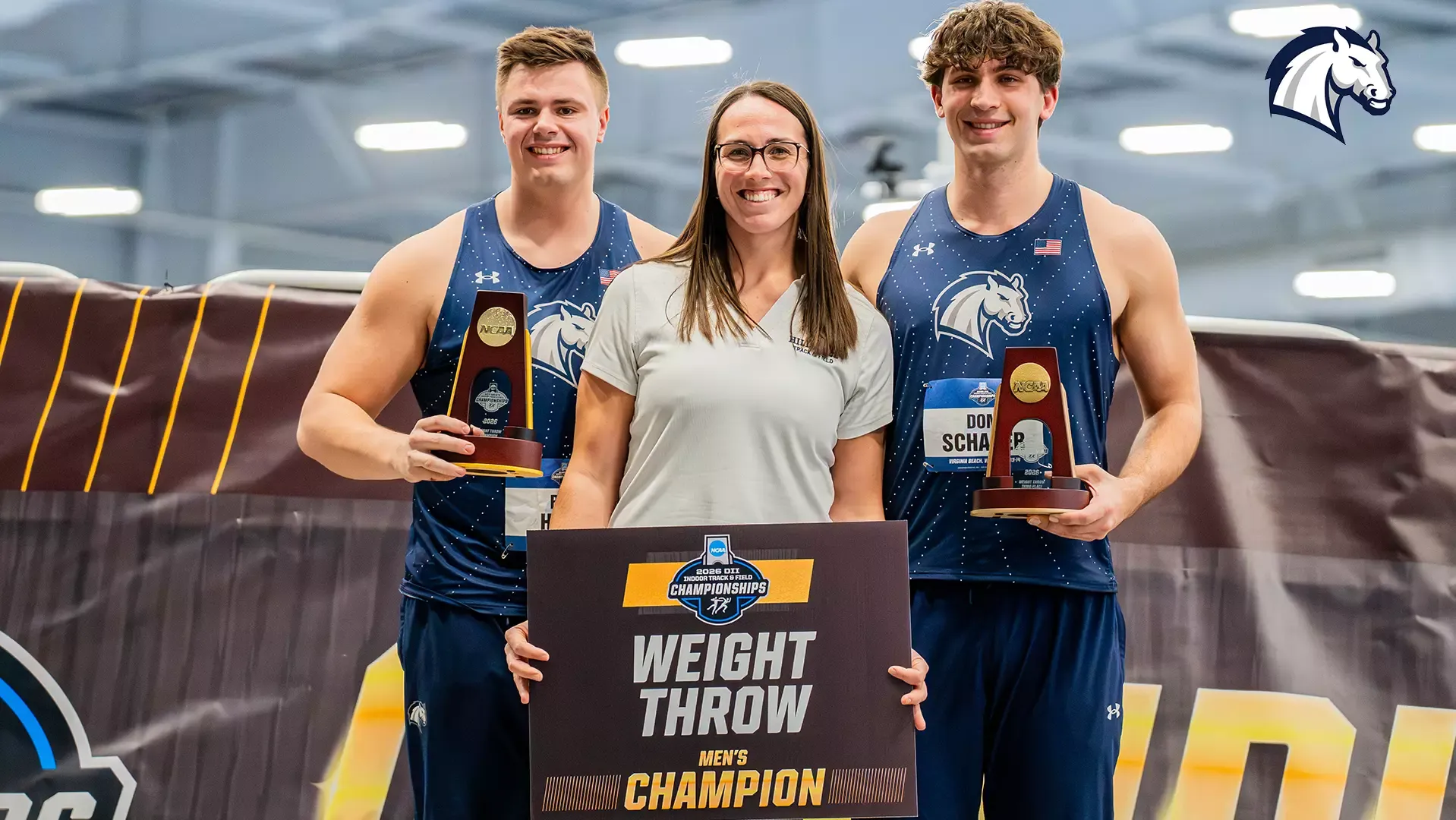 Hillsdale's Ben Haas (left) and Dominic Scharer (right) pose with head coach Jessica Bridenthal after finishing first and third in the NCAA DII Indoor weight throw competition on March 13, 2026.