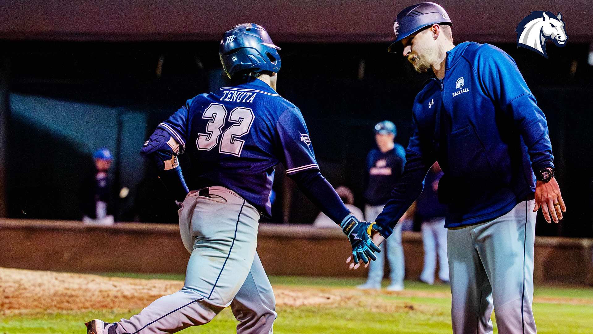 Rocco Tenuta (left) gets a high five from coach Ryan Van Amburg as he rounds the bases after hitting a home run against Montevallo on Jan. 30, 2026.
