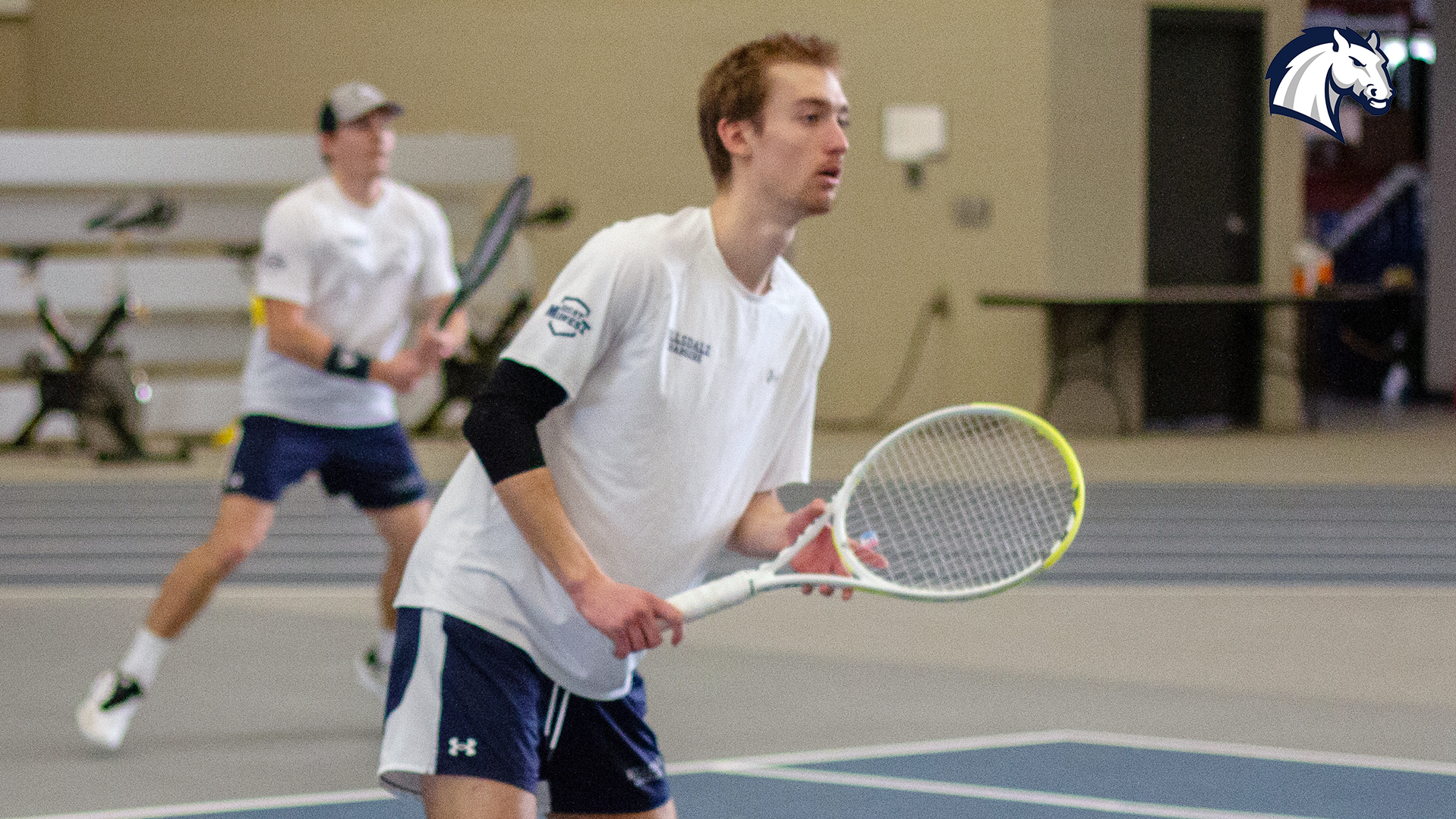 Hillsdale's Henry Hammond waits to return a serve during doubles play against Wayne State on Feb. 28, 2026.