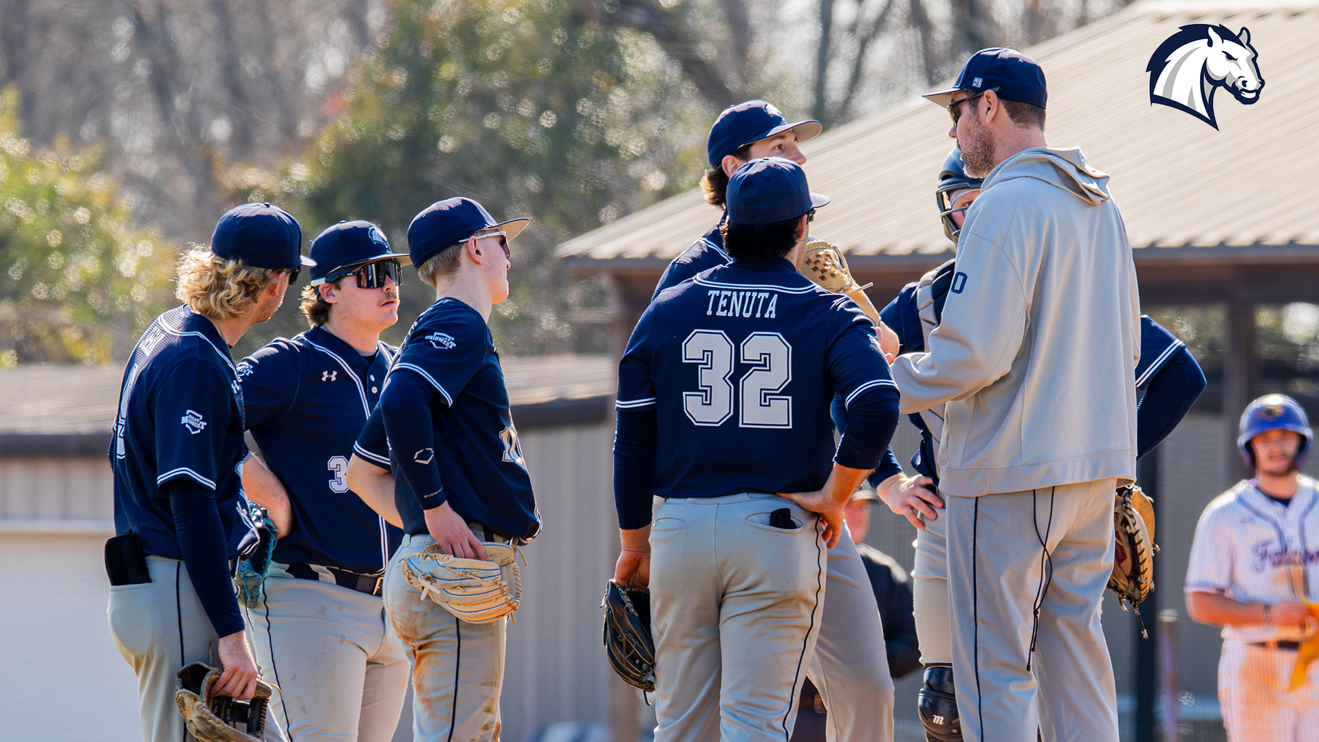Head coach Tom Vessella holds a mound meeting with his team during a Jan. 30, 2026 contest at Montevallo.