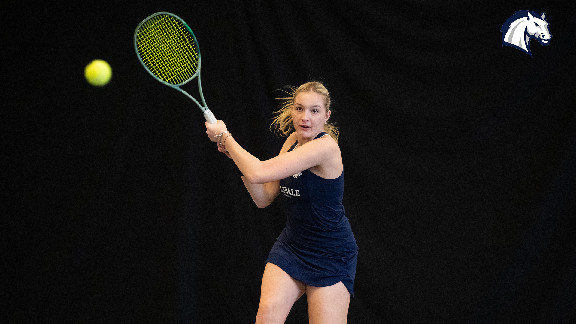 Hillsdale's Emma Palus hits a return shot during a match against Goshen on Feb. 7, 2026.