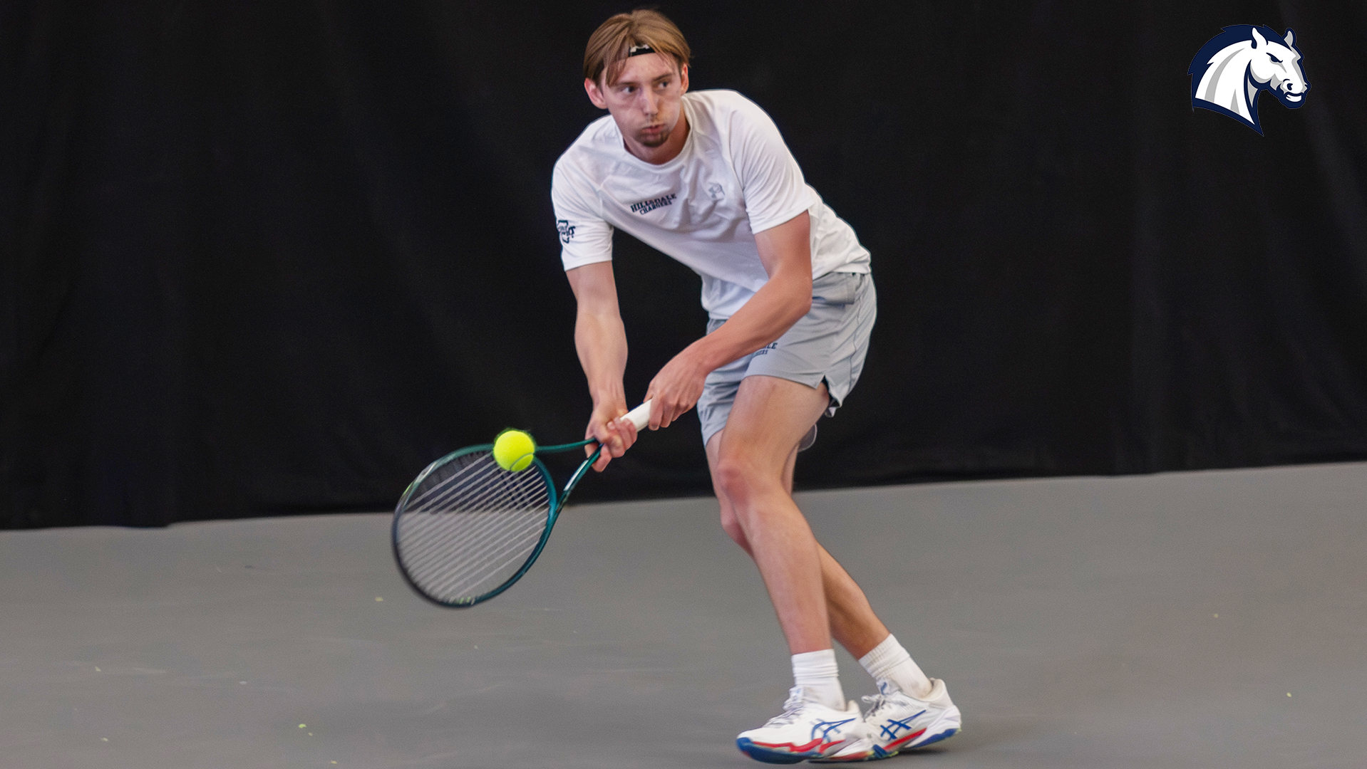 Hillsdale's Sam Plys hits a return shot during a match against Tiffin on March 28, 2026.
