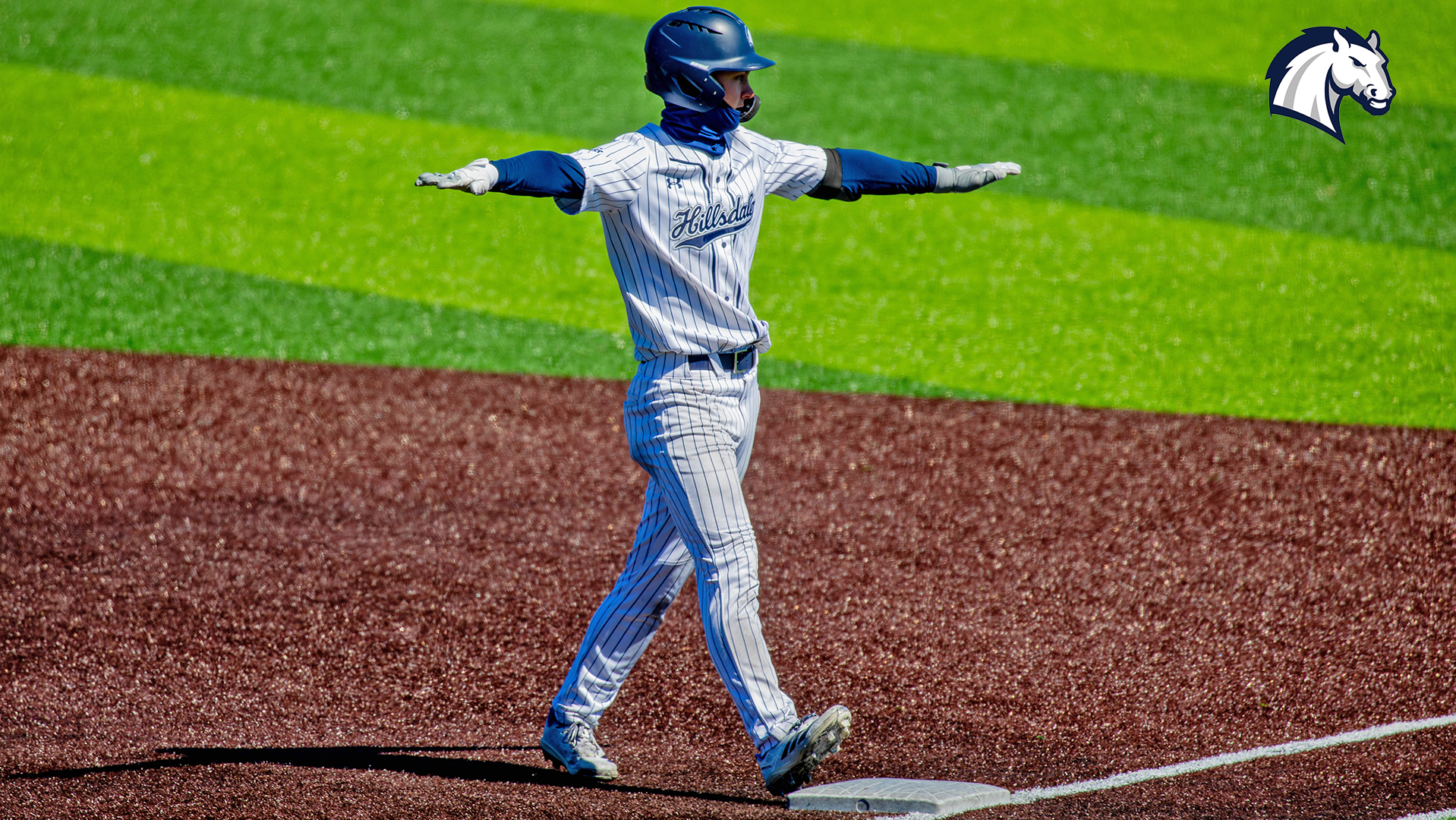 Hillsdale's Billy Porotsky celebrates after reaching first base safely during a home contest in March 2026.