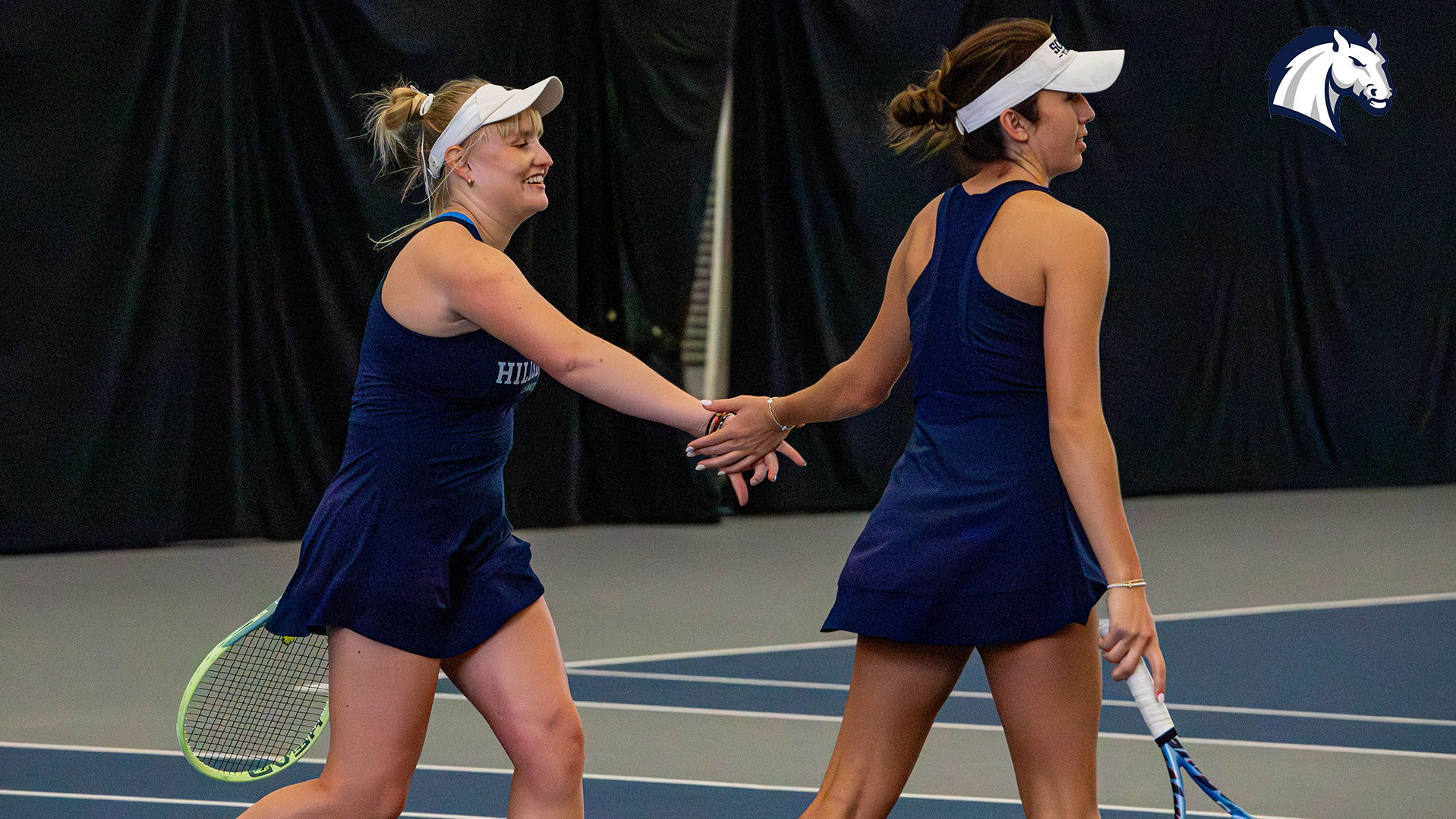 Ane Dannhauser (left) and Briana Rees congratulate each other after winning a doubles point against Kentucky Wesleyan on April 10, 2026.