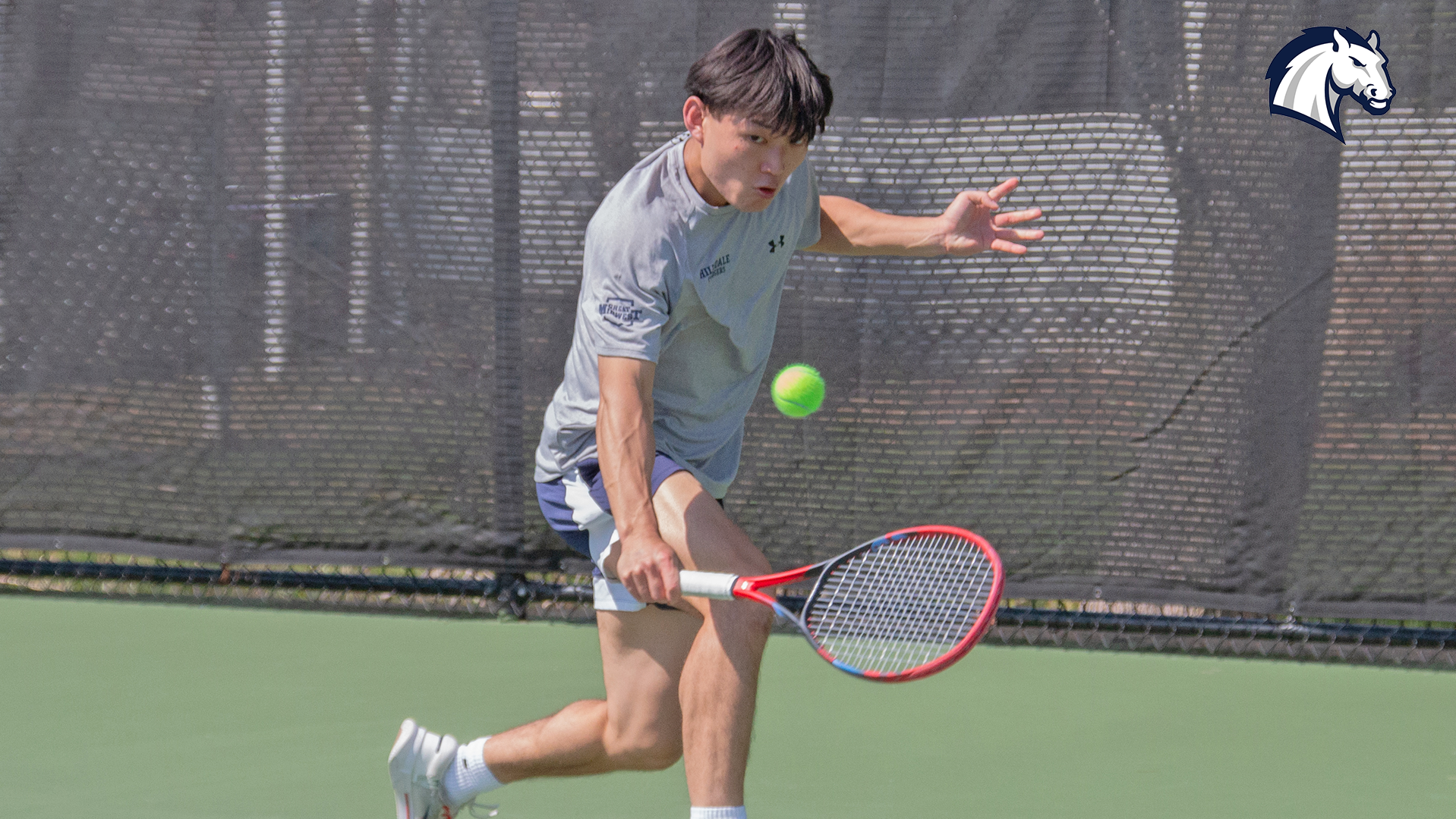 Hillsdale's Rintaro Goda hits a return shot against Thomas More during a match on April 11, 2026.