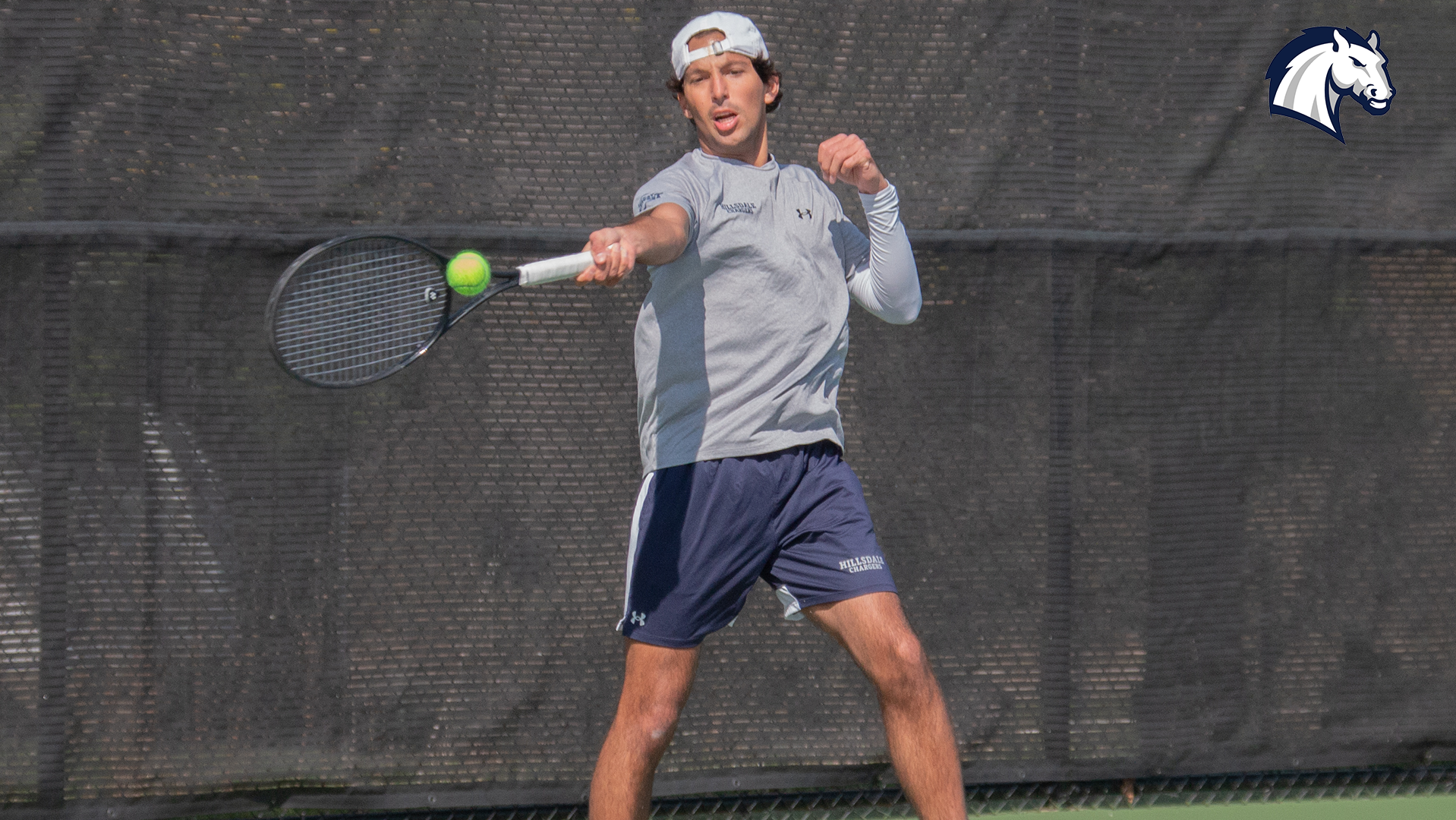 Hillsdale's Jackson Clements hits a return shot during a match against Thomas More on April 11, 2026.