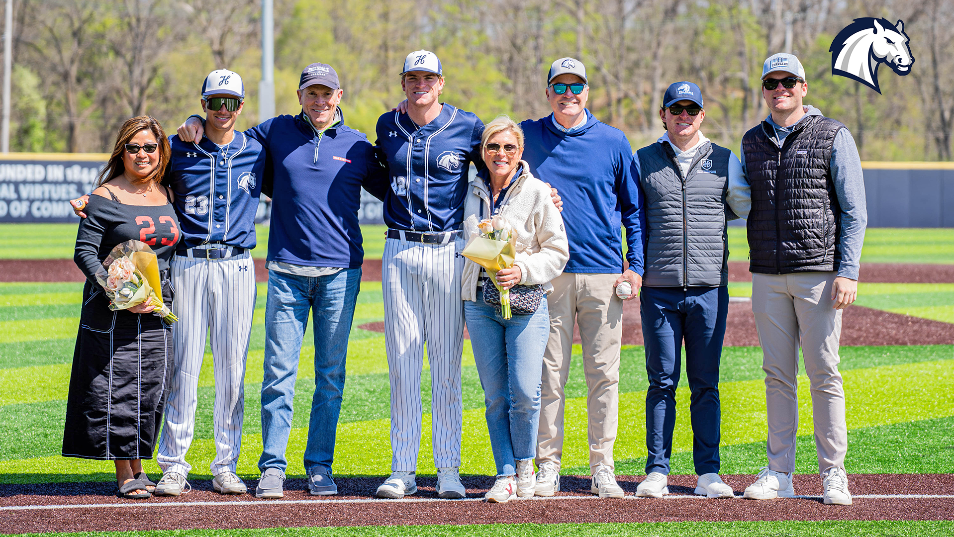 Graduating seniors Tyler Turner (left) and Patrick MacLean (right) pose with their families during senior day festivites on April 26, 2026.