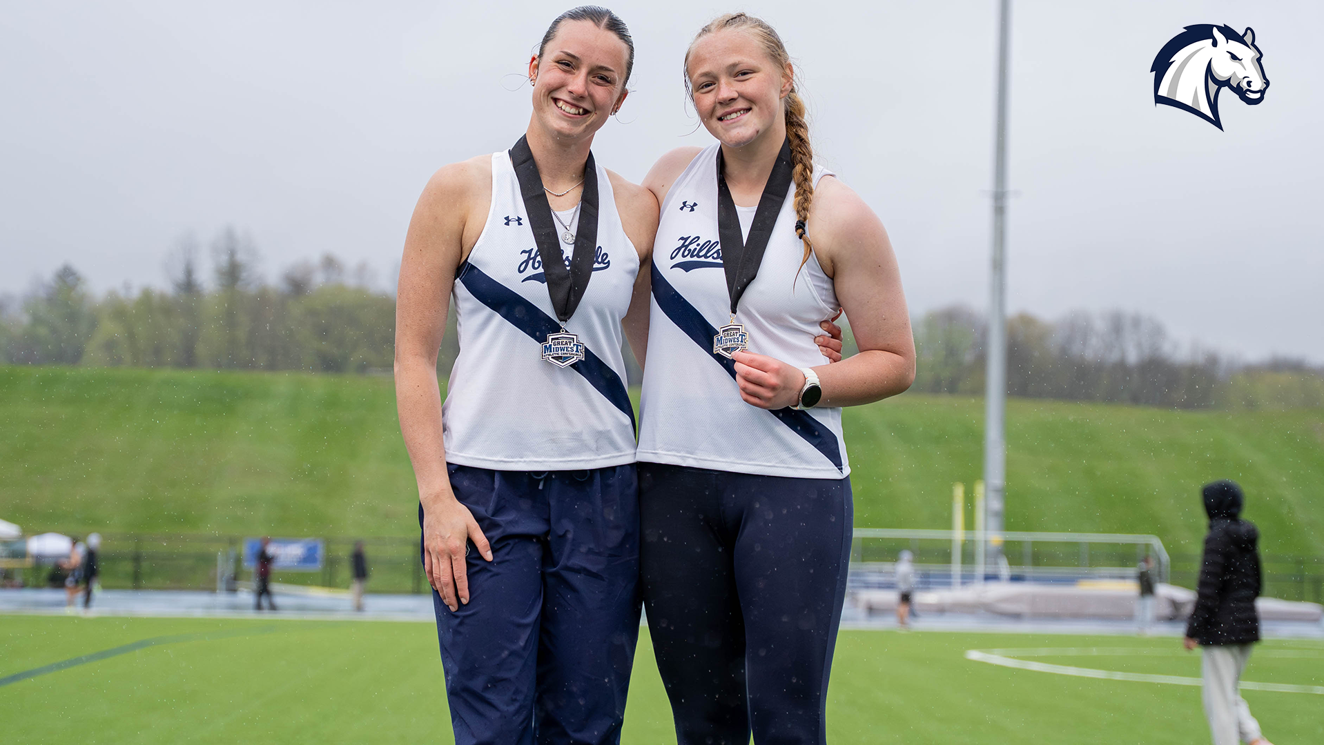 Chargers Devan Foster (left) and Lilly Grubbs pose on the medal stand after finishing in the top three at the 2026 G-MAC Outdoor Championships.