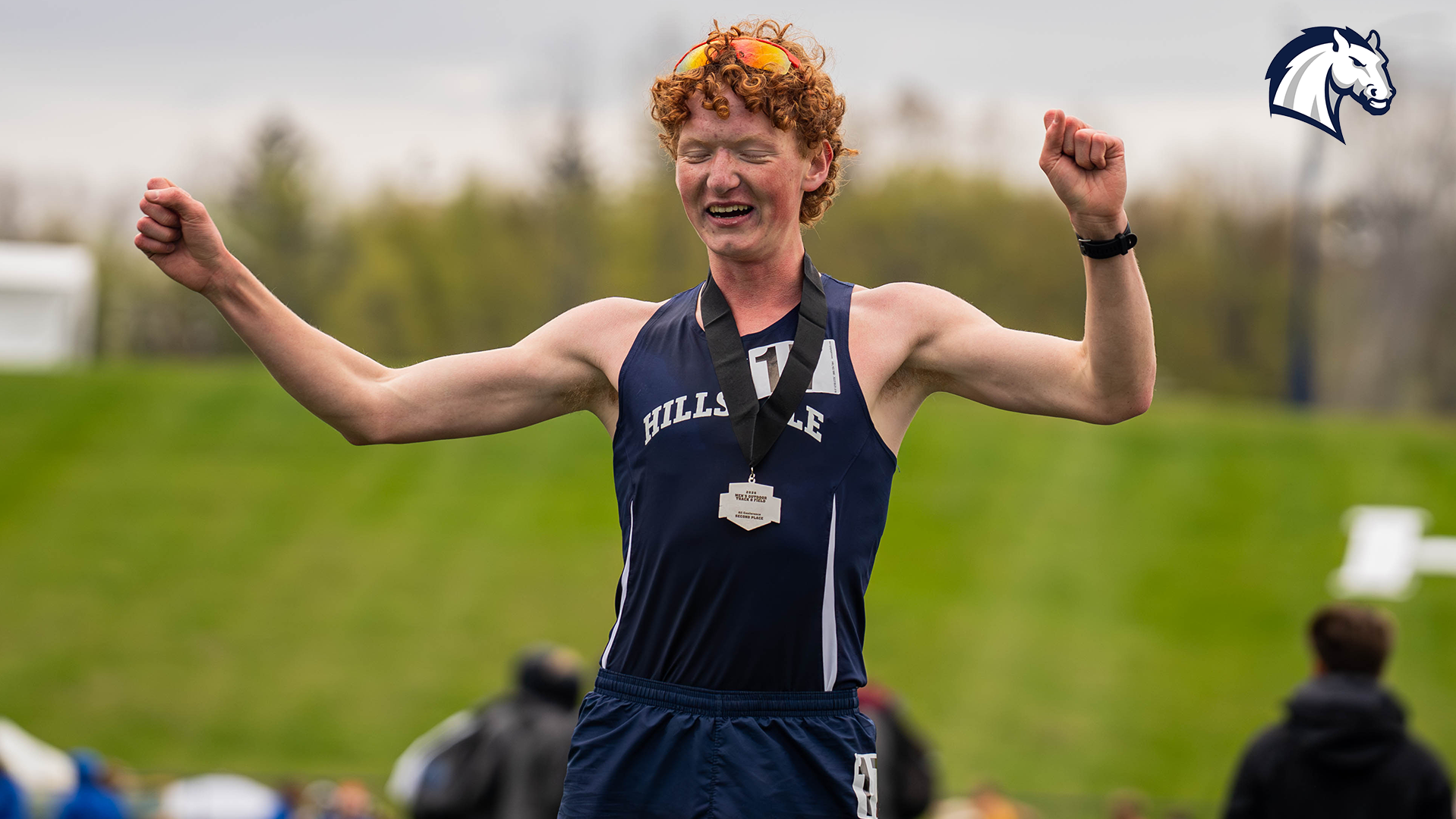 Hillsdale's Jefferson Regitz celebrates with his medal after a runner-up finish in the 3,000m steeplechase at the 2026 G-MAC Outdoor Championships.