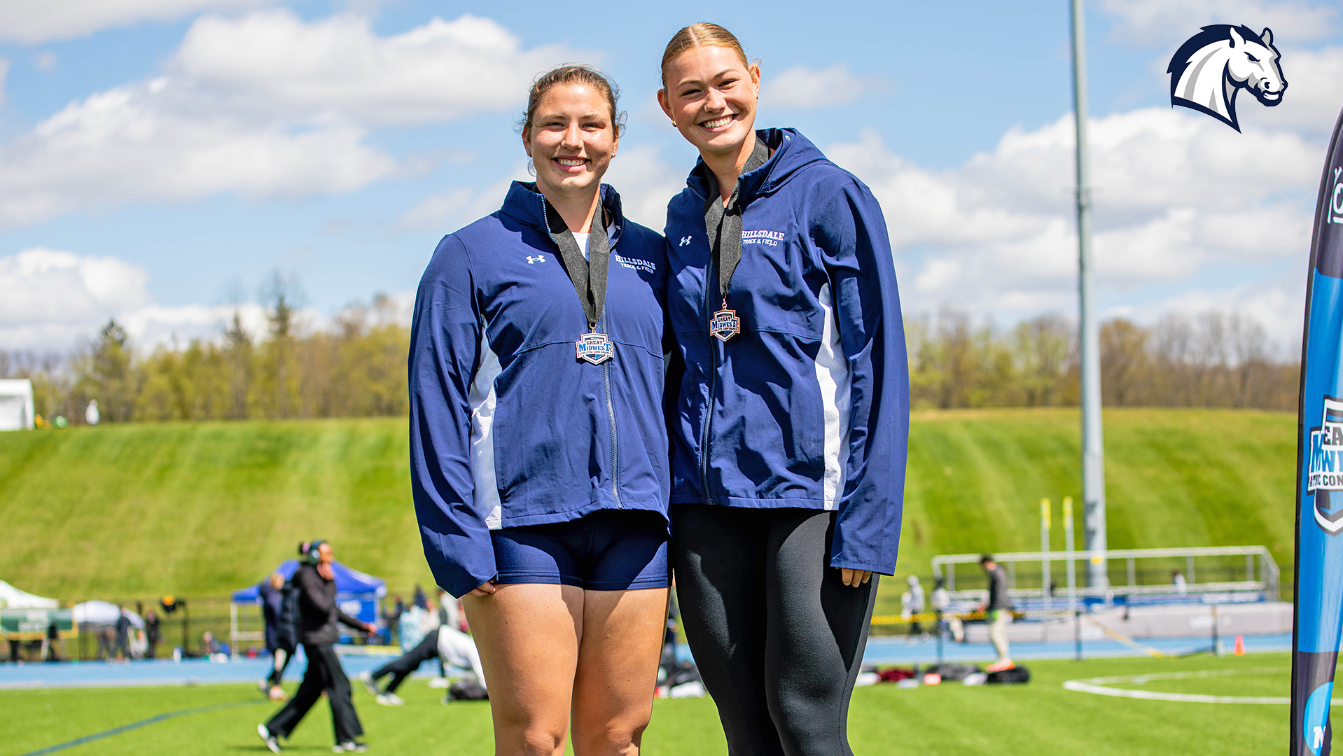 Hillsdale's Amelia Lutz (left) and Sofia Boonzaaijer (right) pose with medals after finishing in the top three in the shot put at the 2026 G-MAC Outdoor Championships.