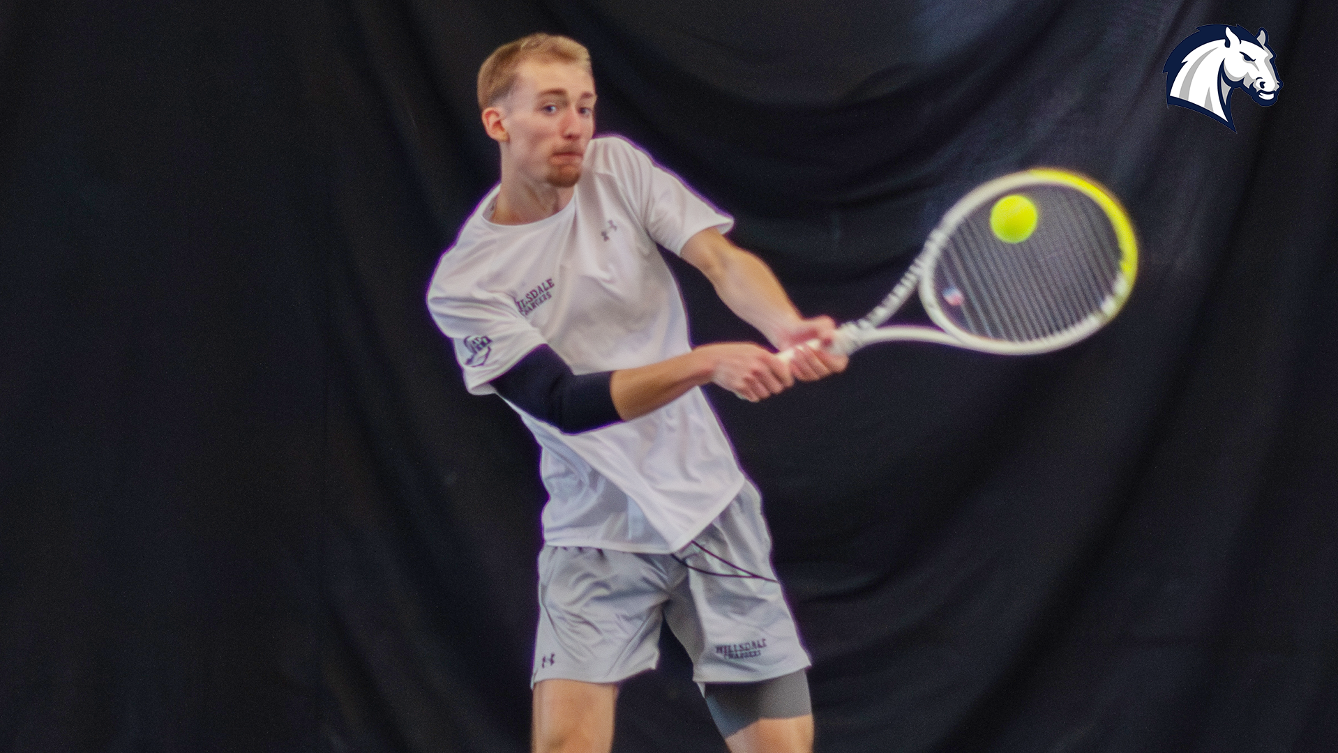 Hillsdale's Henry Hammond hits a return shot during a match against Tiffin on March 28, 2026.