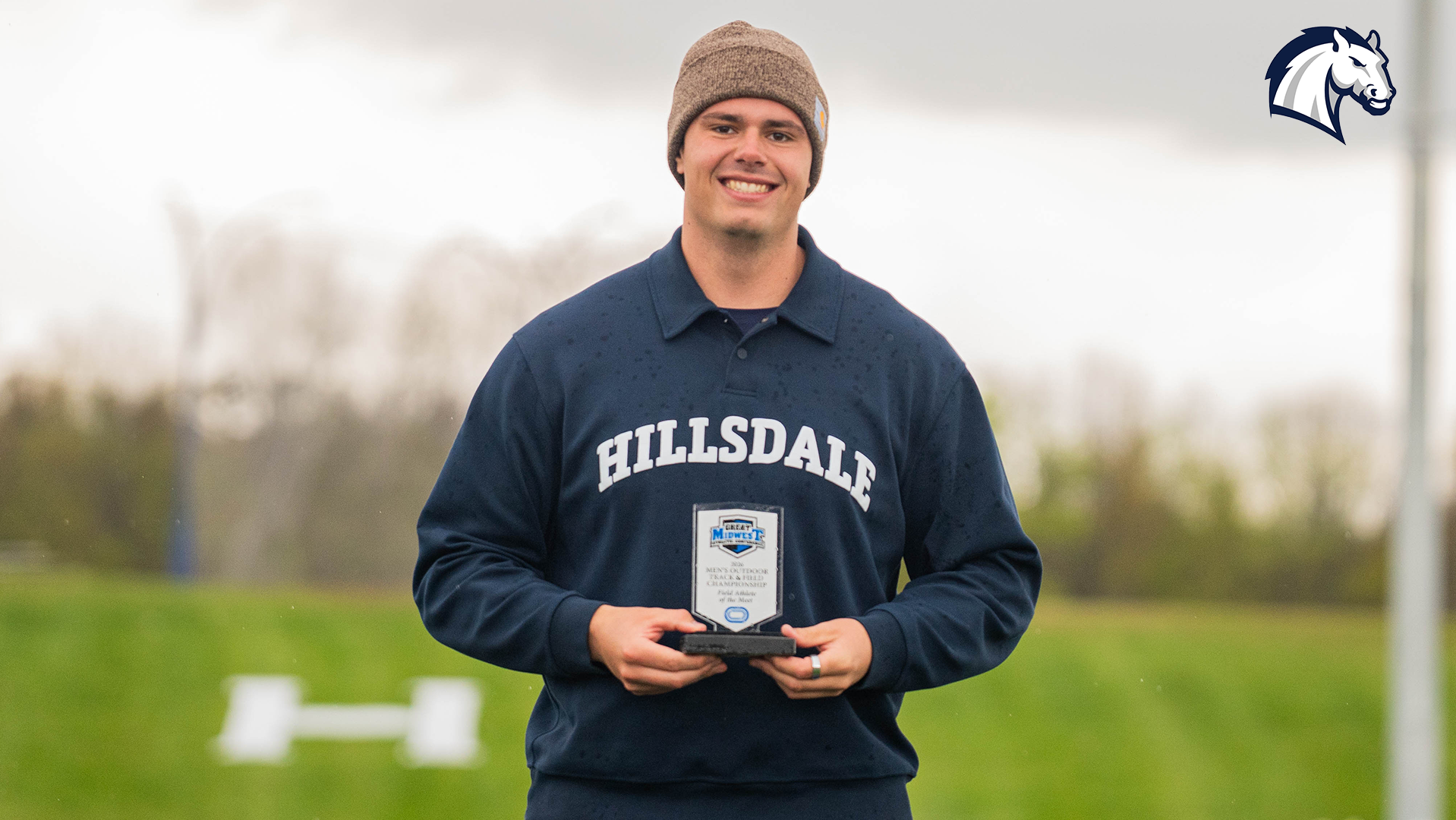 Hillsdale's Ben Haas poses with the G-MAC Field Athlete of the Meet trophy at the 2026 G-MAC Outdoor Championships on May 1.