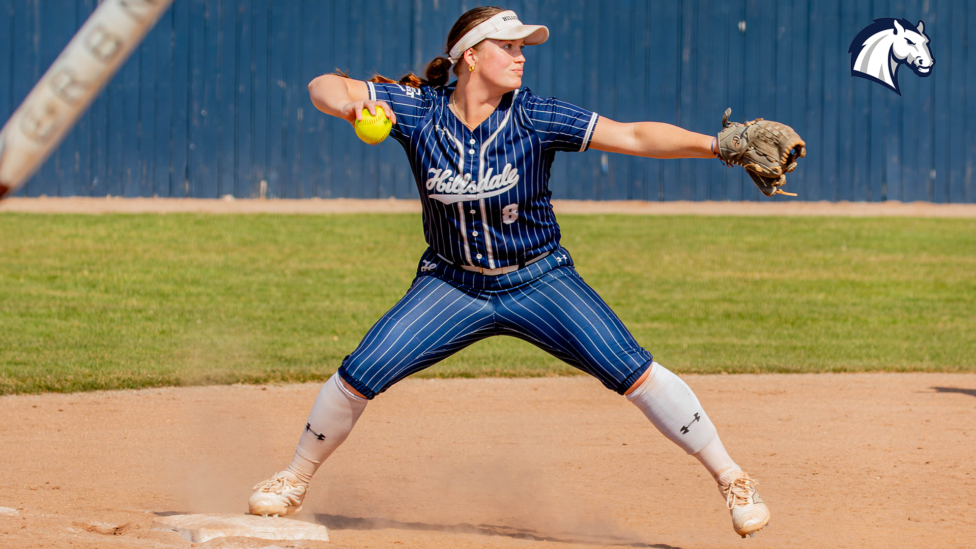 Hillsdale's Anna Chellman prepares to throw a runner out from third base against Cedarville in March 2026.