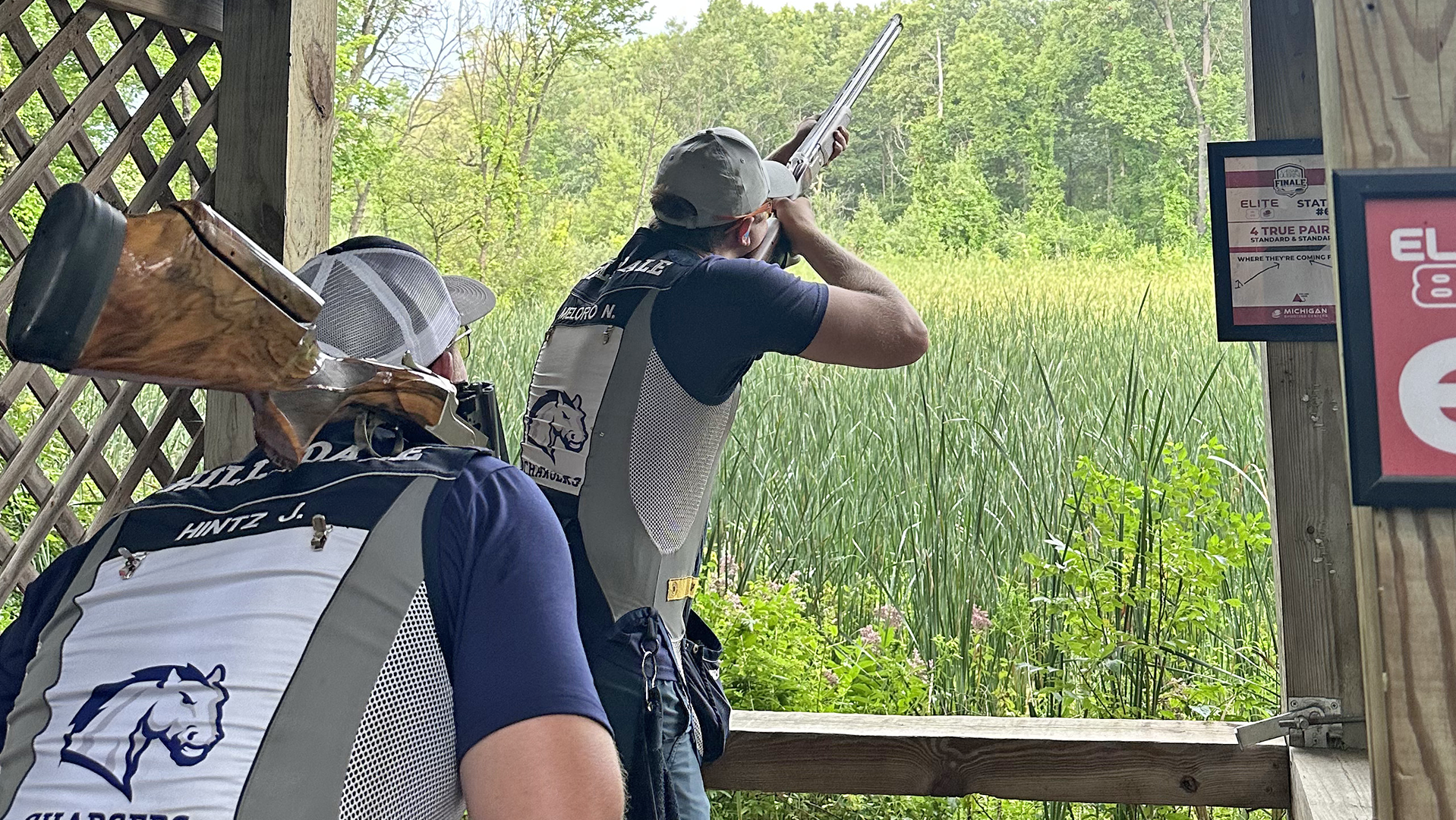 Hillsdale's Nathaniel Meloro (foreground) competes in the Lieske Signature Shoot while coach Jordan Hintz watches.