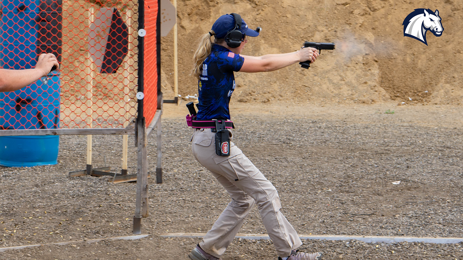 Clara Bozzay competes in an action shooting match during the 2025-26 season.