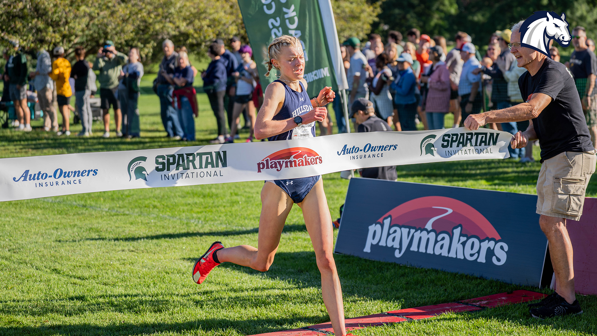 Hillsdale's Allison Kuzma breaks the tape to win the 2026 Spartan Invitational title on Sept. 11 in East Lansing.