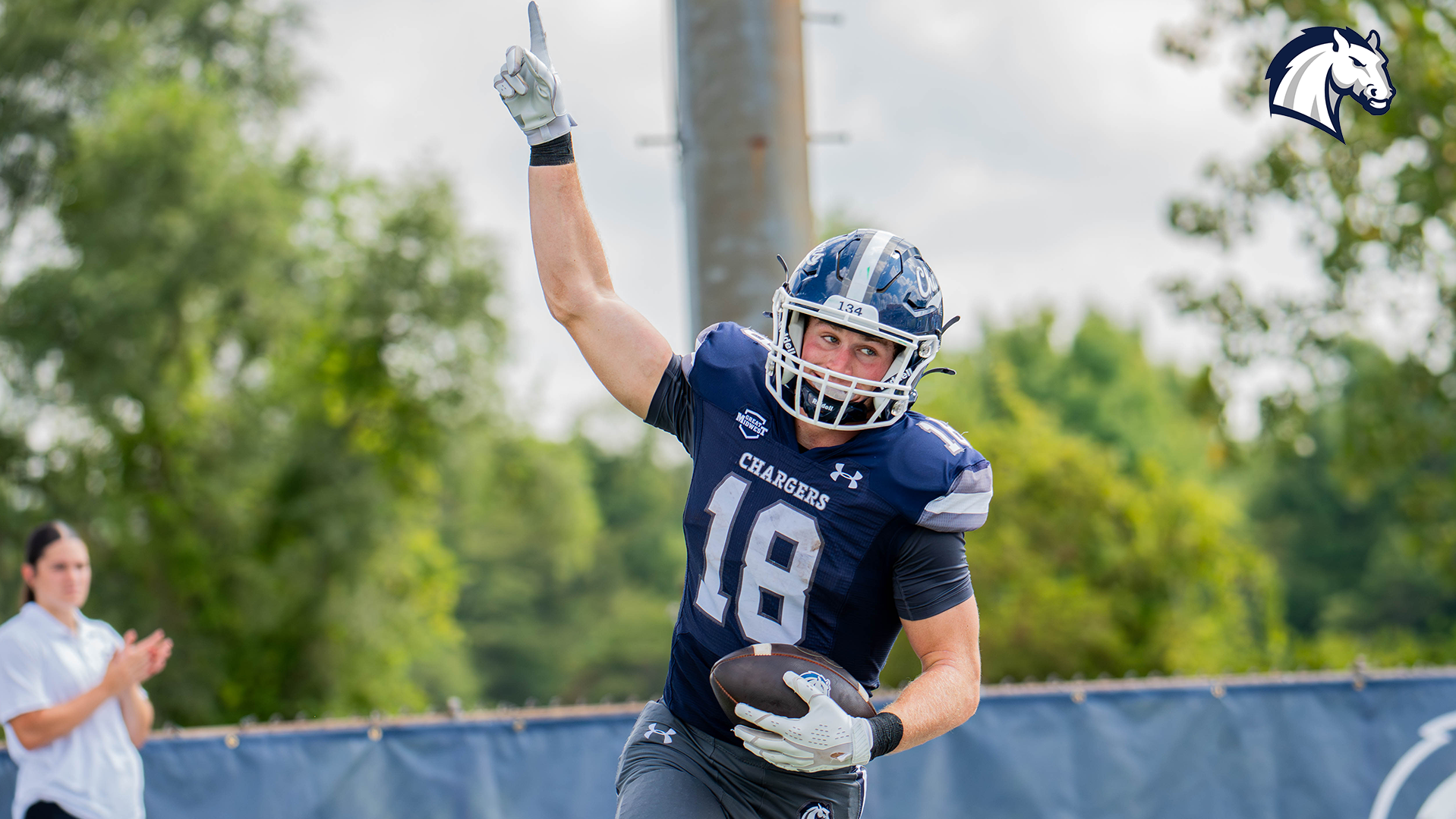 Hillsdale's Tutt Carrico raises his arm in celebration after scoring a touchdown in a 49-0 win over Wayne State on Sept. 12, 2026.